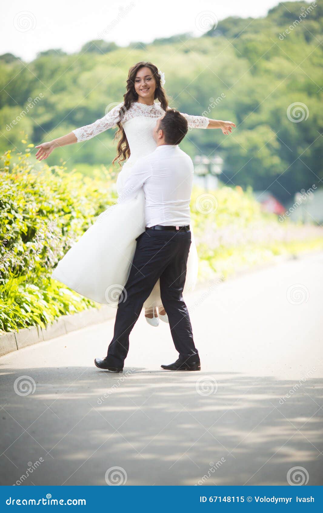 Stylish Gorgeous Happy Brunette Bride And Elegant Groom Walking Stock