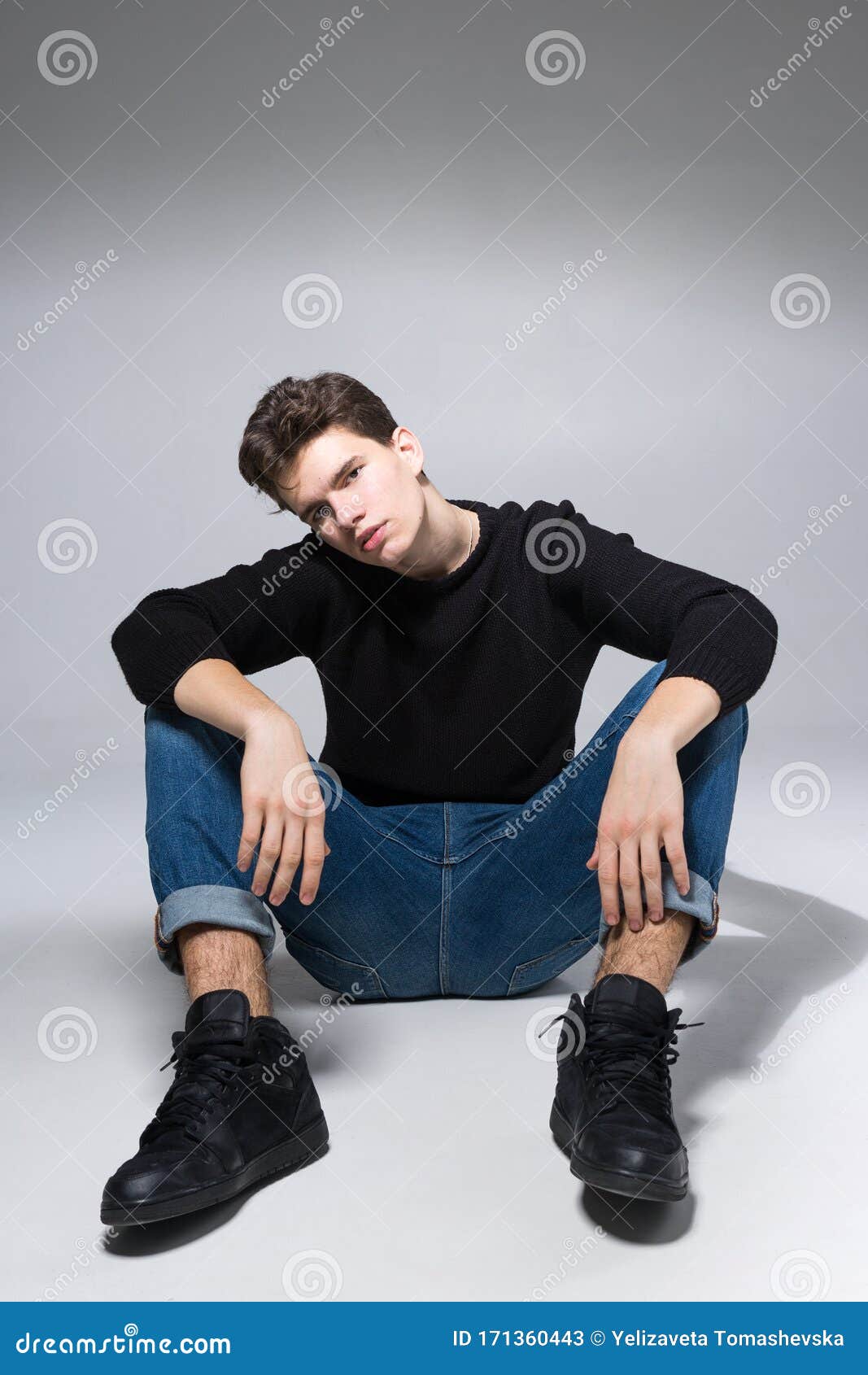 Stylish Handsome Man Posing Sitting on Floor. Handsome Guy Stock Image -  Image of pensive, jeans: 171360443