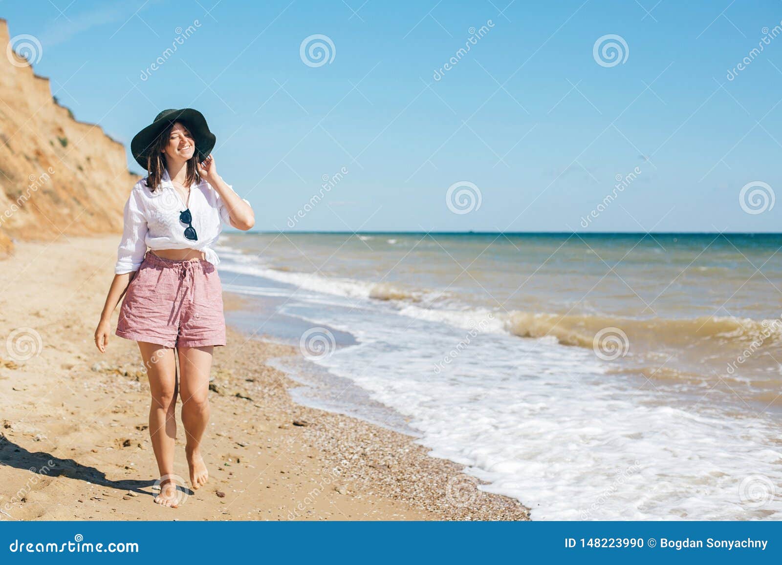 Stylish Hipster Girl in Hat Walking on Beach and Smiling. Summer ...