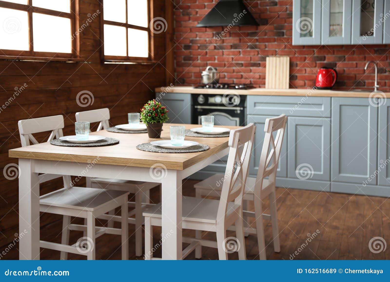 Stylish Kitchen Interior with Table and Chairs Stock Image - Image of