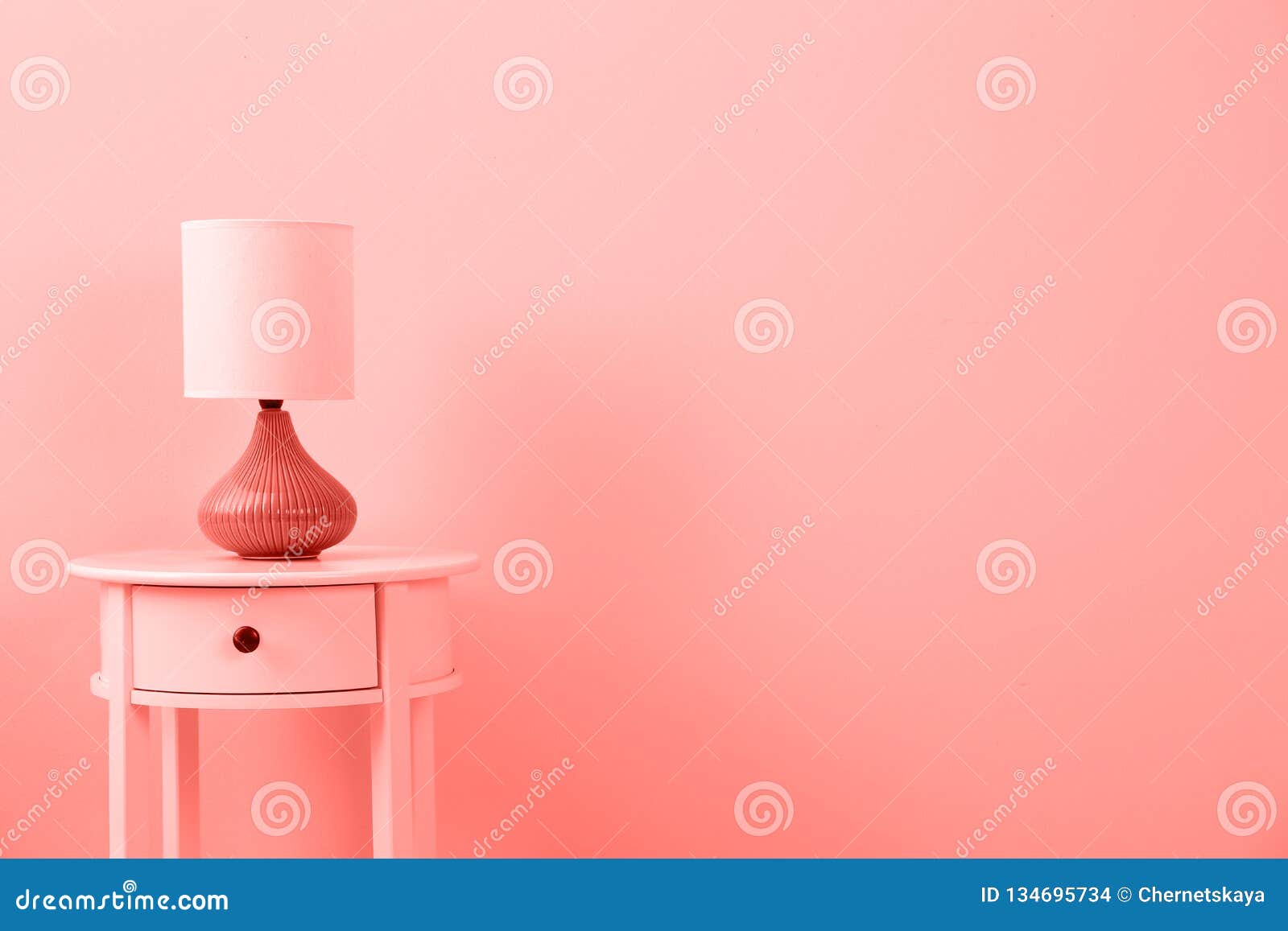 Stylish Lamp On Table Against Color Wall Space For Text Stock