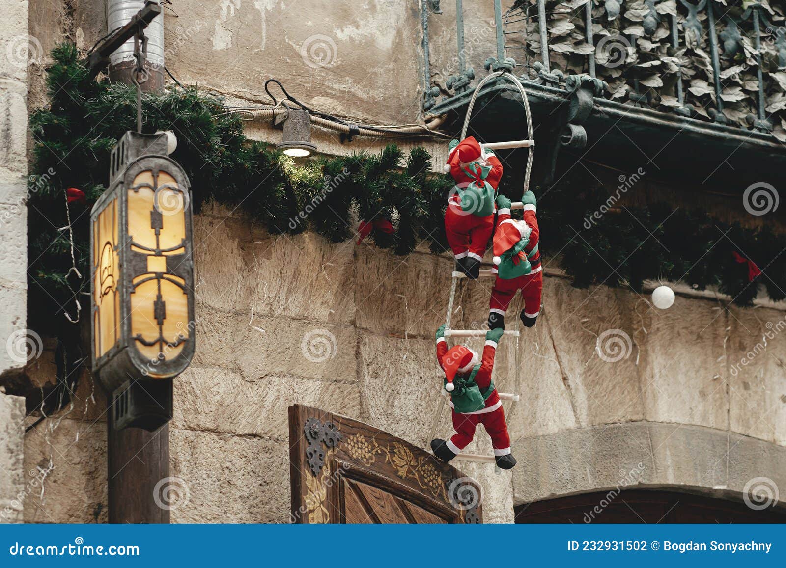 Stylish Little Santa Clauses Climbing on Ladder on Balcony of Old ...