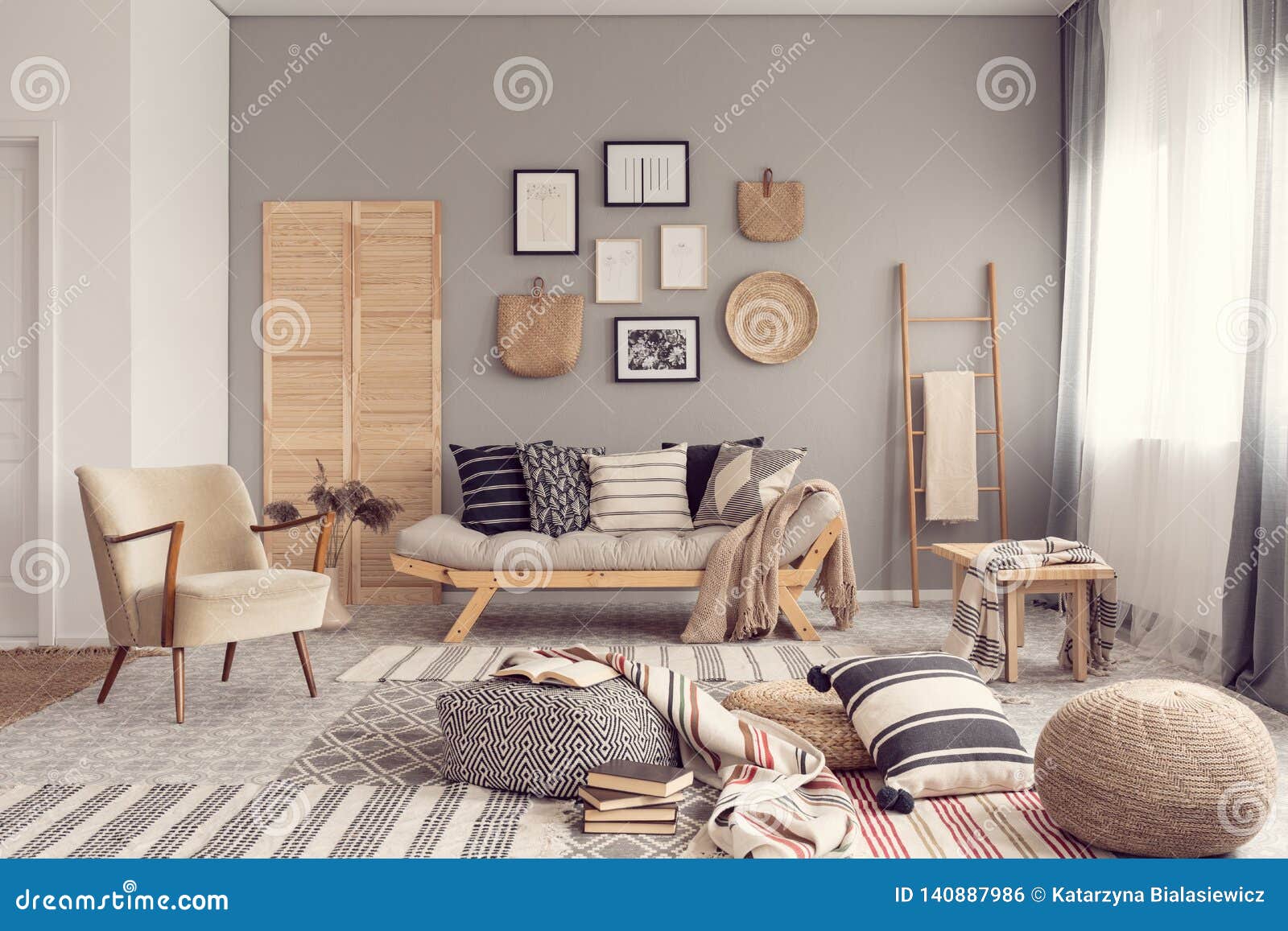 stylish living room interior  with scandinavian settee, grey wall and natural accents