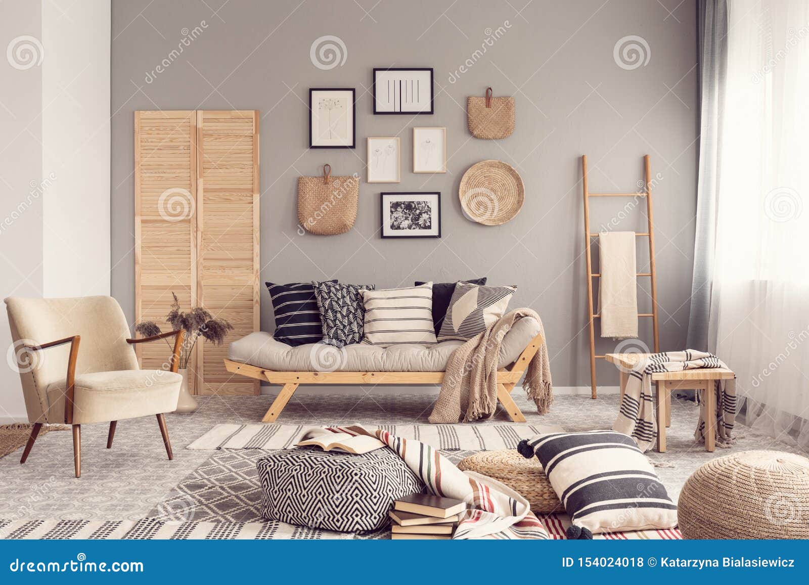stylish living room interior  with scandinavian settee, grey wall and natural accents