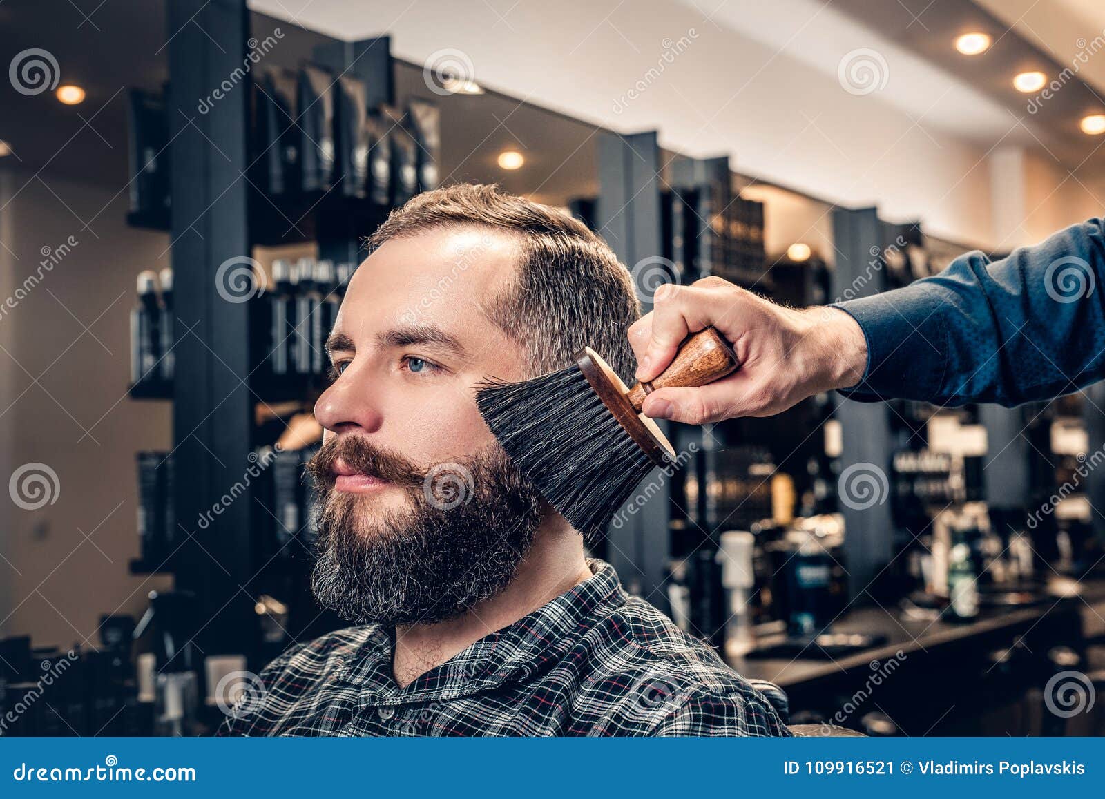Hairdresser Doing Haircut To a Bearded Man in a Barbershop. Stock Image ...