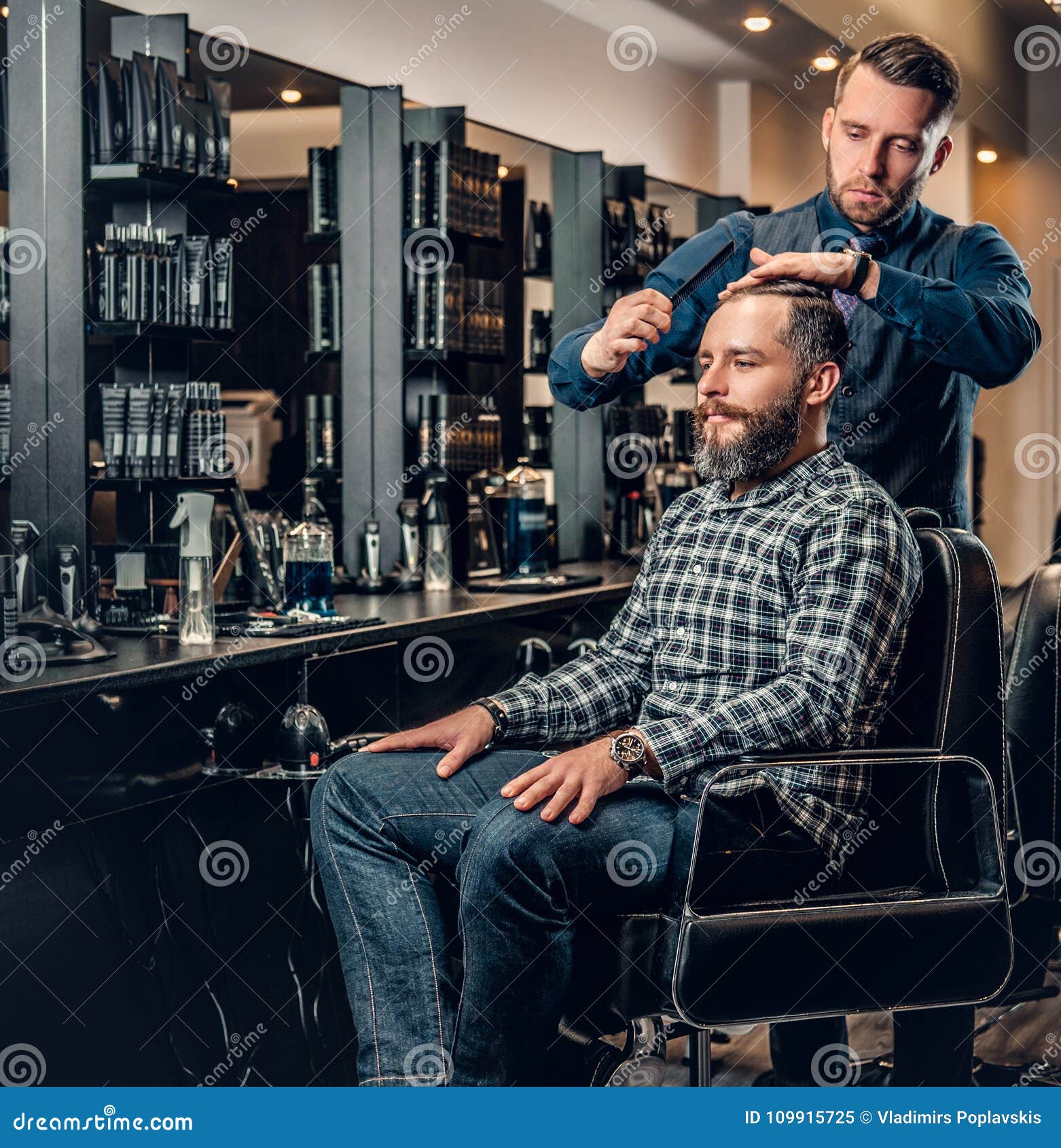 Stylish Male Hairdresser Doing Haircut To a Bearded Male in a Sa Stock ...
