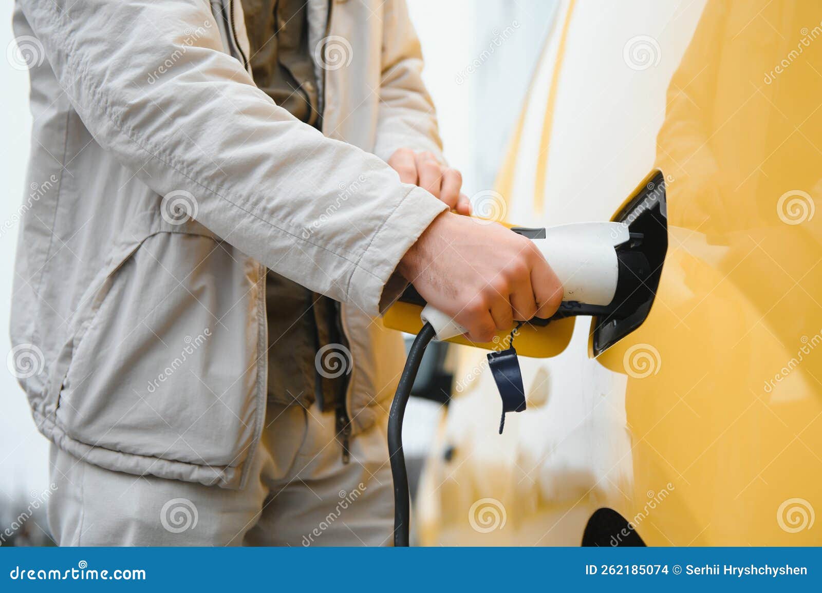 Stylish Man Inserts the Charging Cable into the Socket of Electric Car Stock Photo Image of
