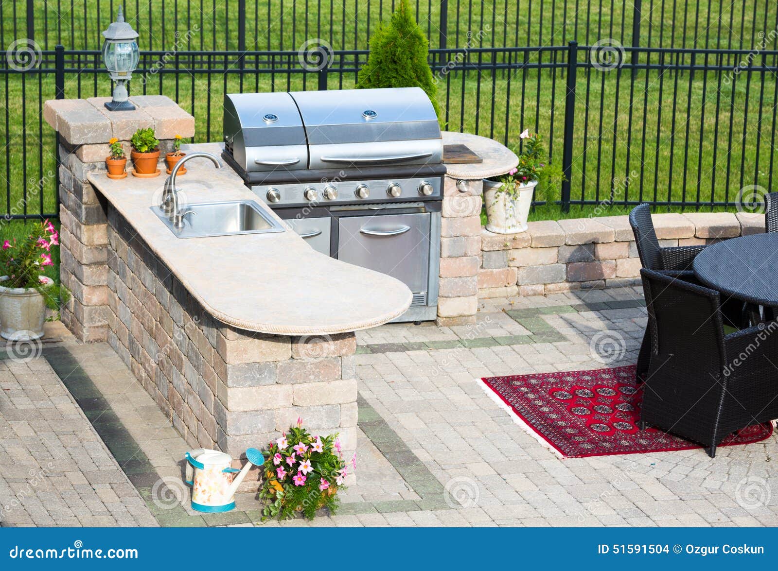 stylish outdoor kitchen on a brick patio