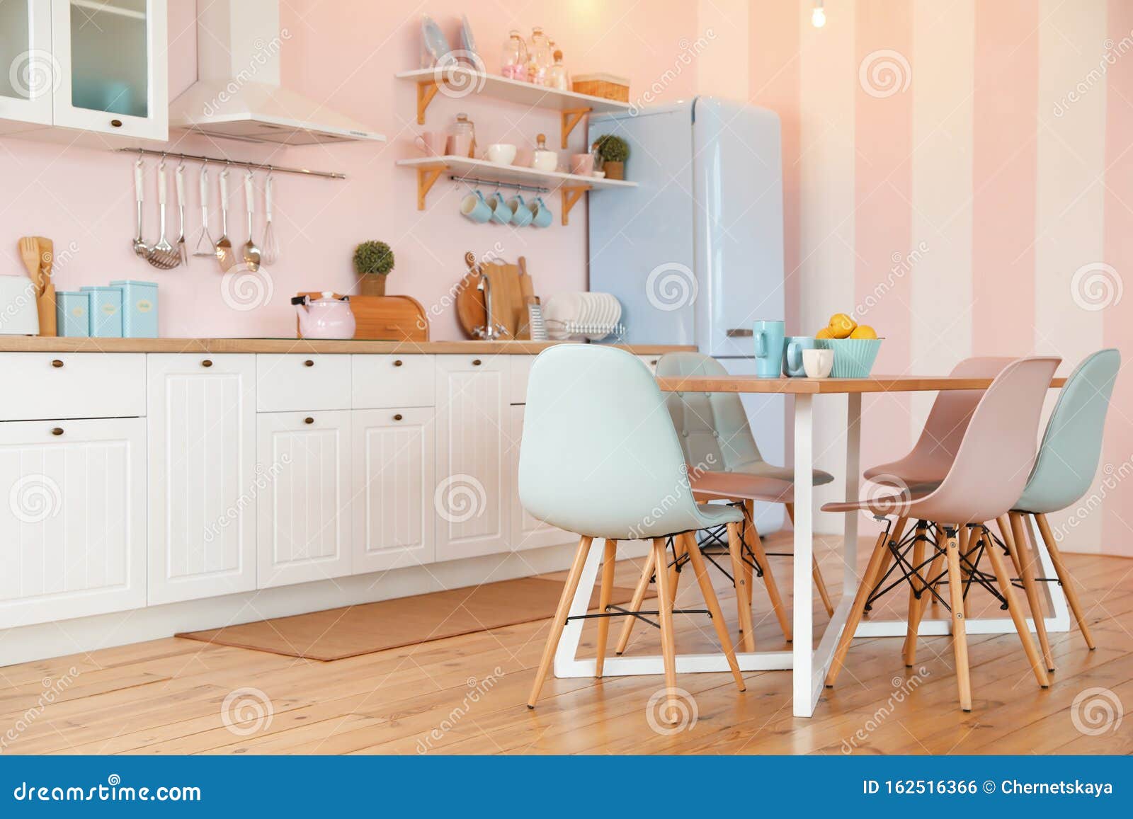 Stylish Pink Kitchen Interior with Table and Chairs Stock Photo Image