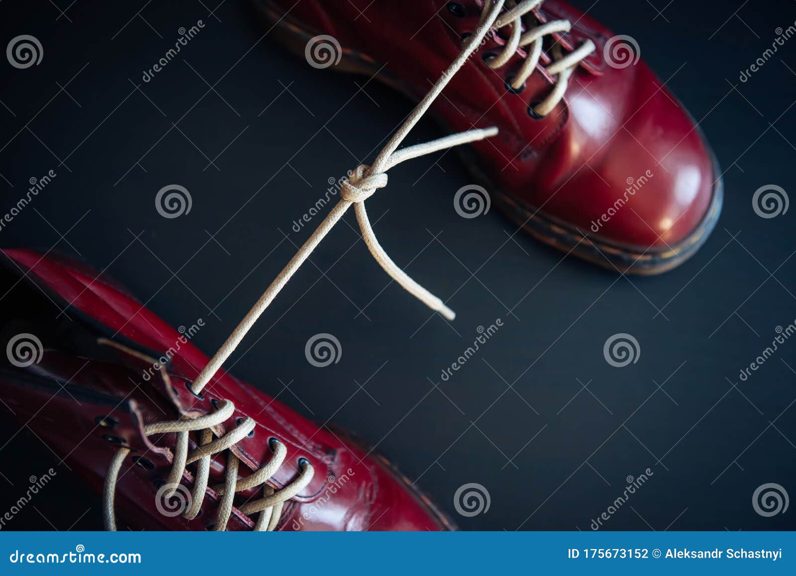 Stylish Red Shoes with Laces Linked Together on Black Background. High ...