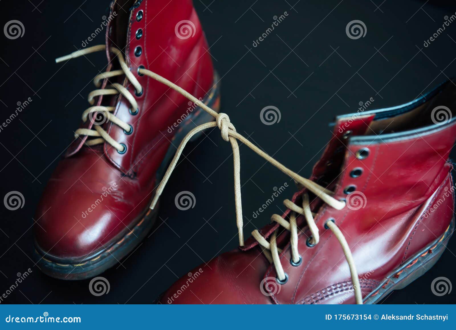 Stylish Red Shoes with Laces Linked Together on Black Background. High ...