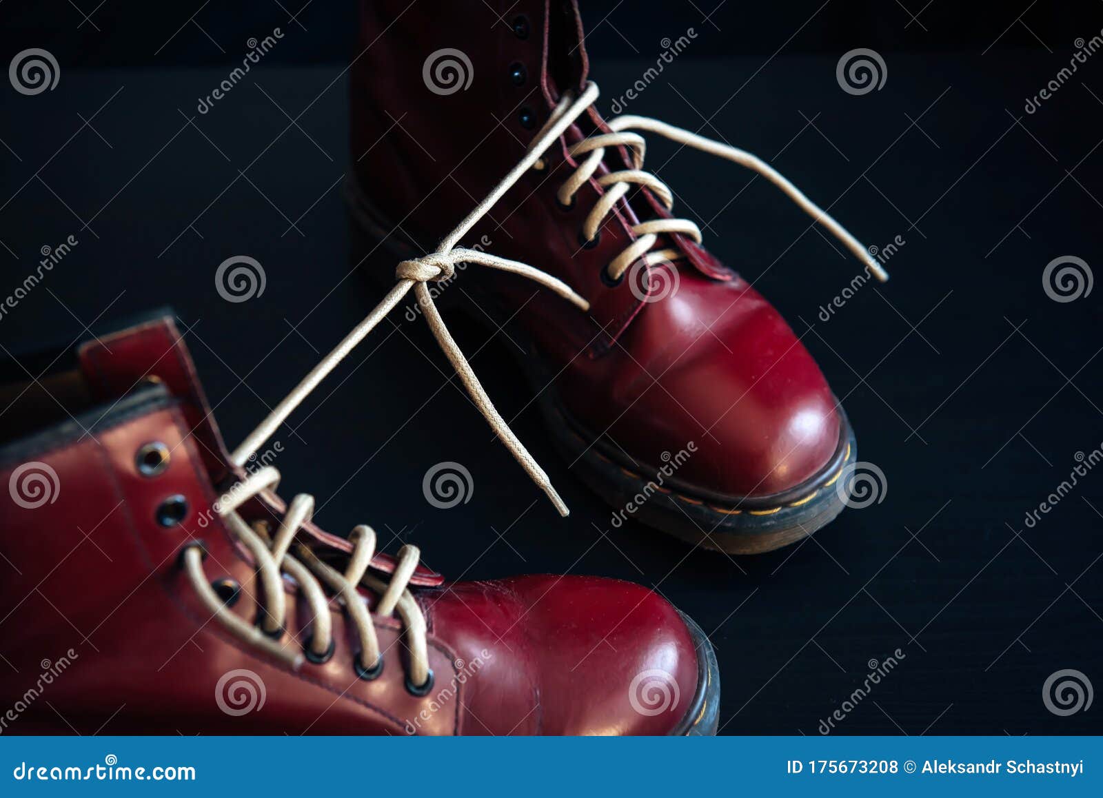 Stylish Red Shoes With Laces Tied Together On Black Background ...