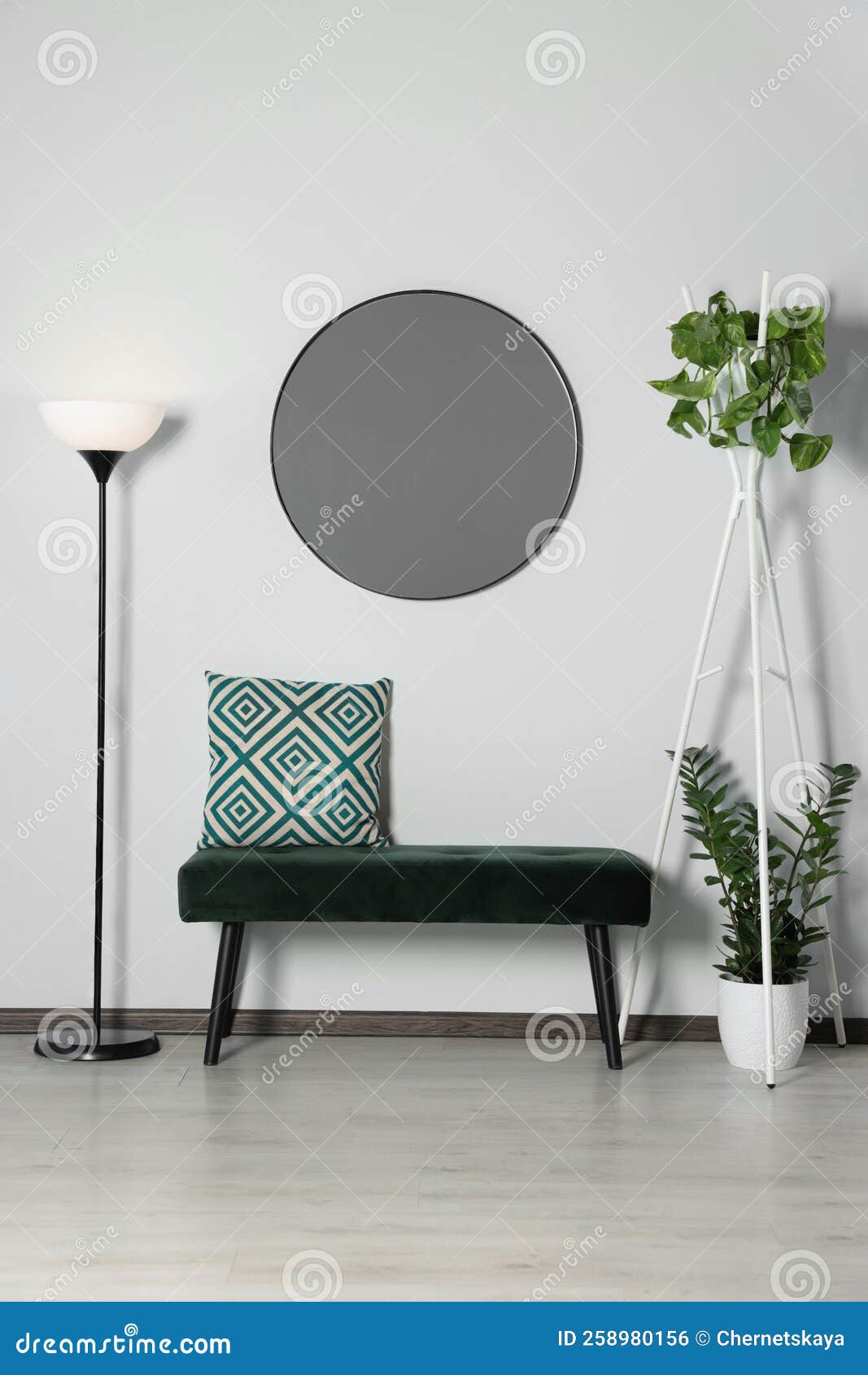 Stylish Round Mirror on White Wall Over Bench in Room Stock Photo