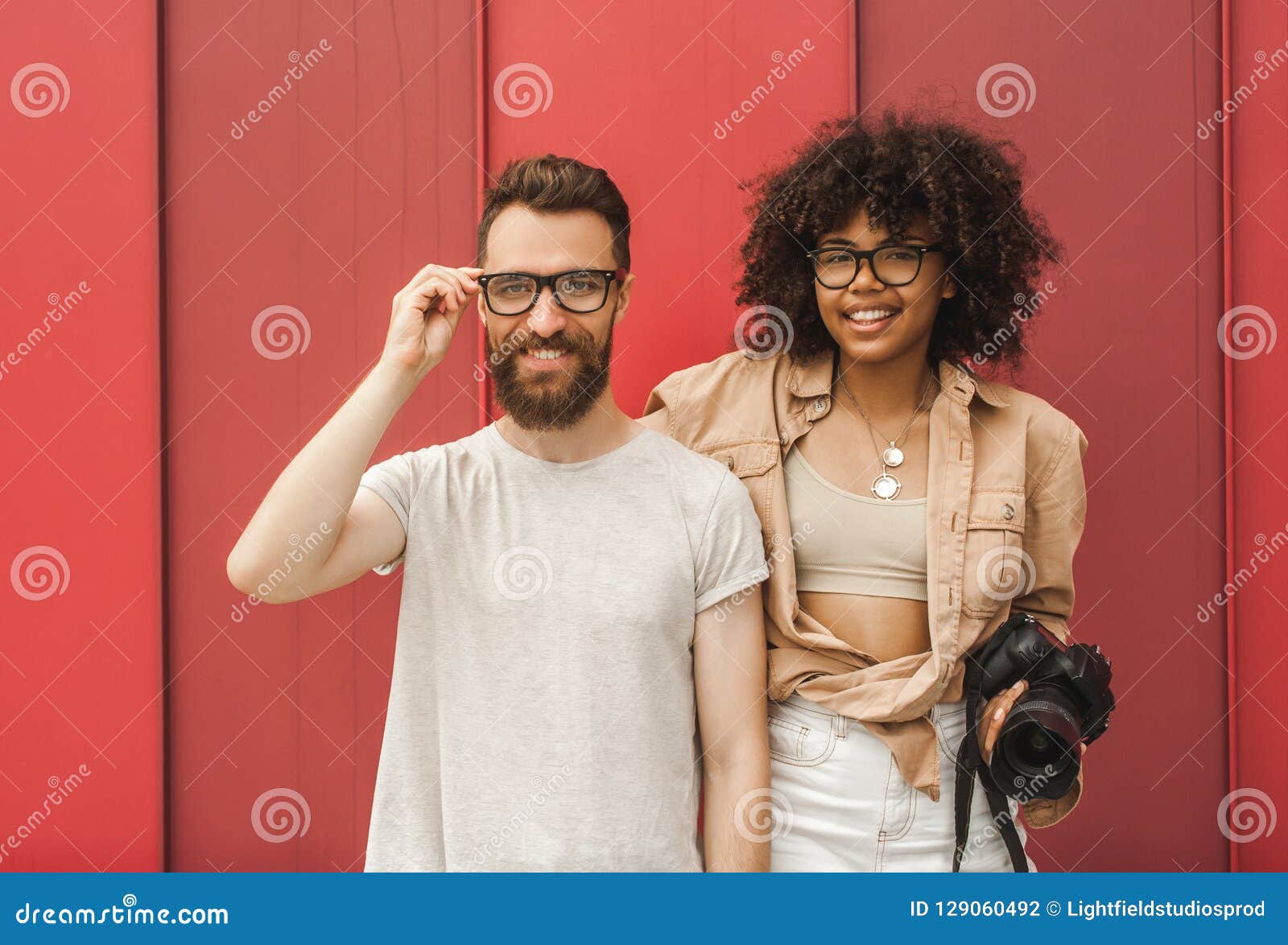 Stylish Smiling Young Multiracial Couple in Eyeglasses Holding Stock ...