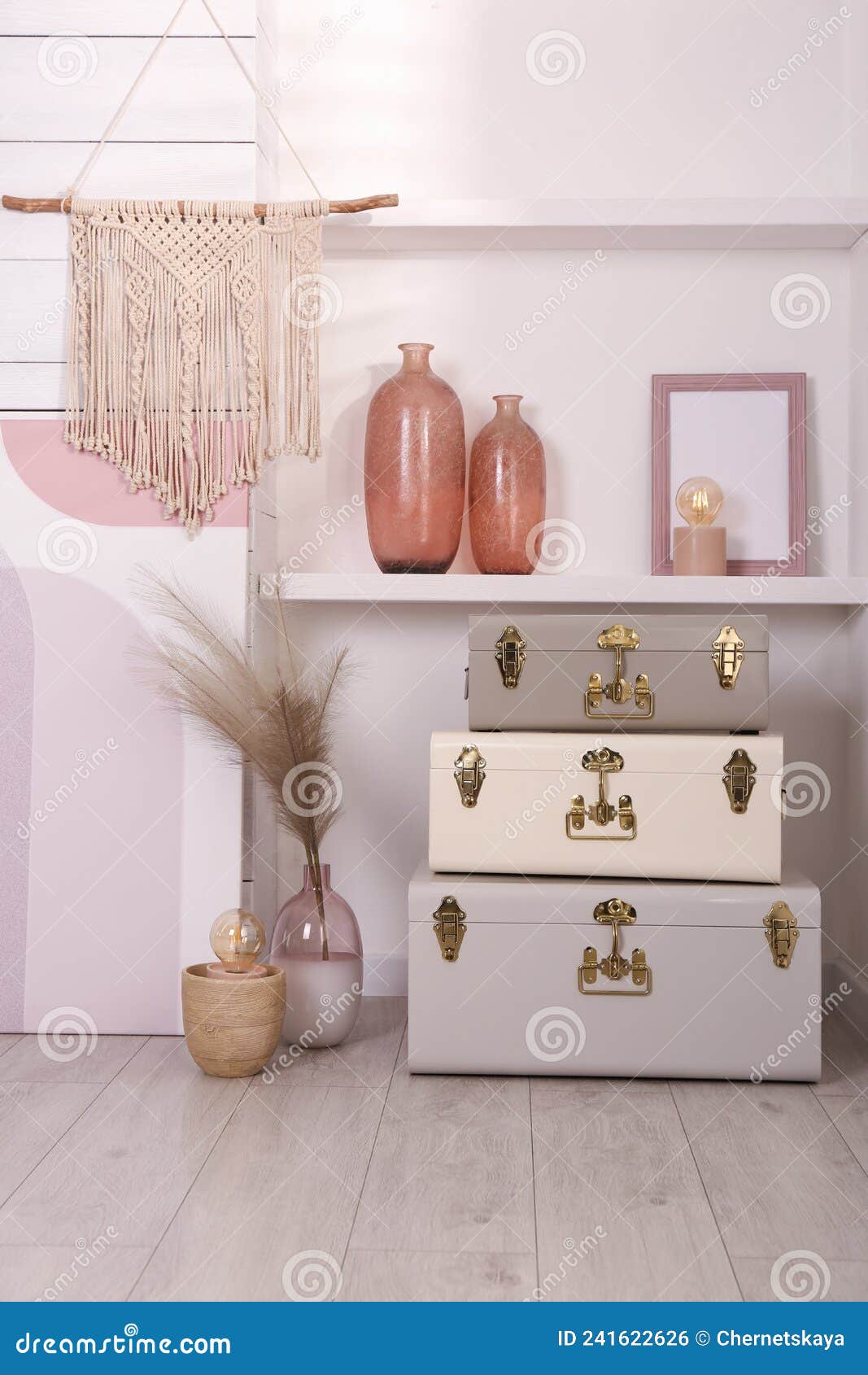 Stylish Storage Trunks and Different Decor Elements Near White Wall