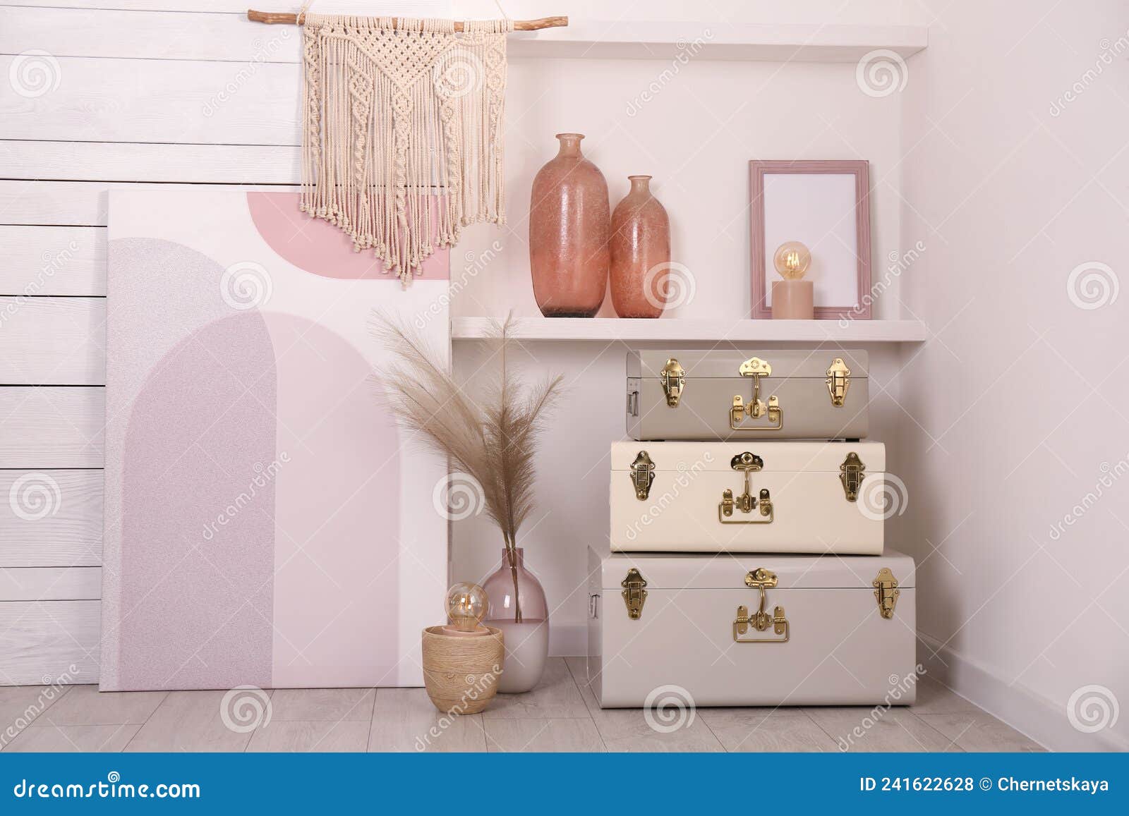 Stylish Storage Trunks and Different Decor Elements Near White Wall