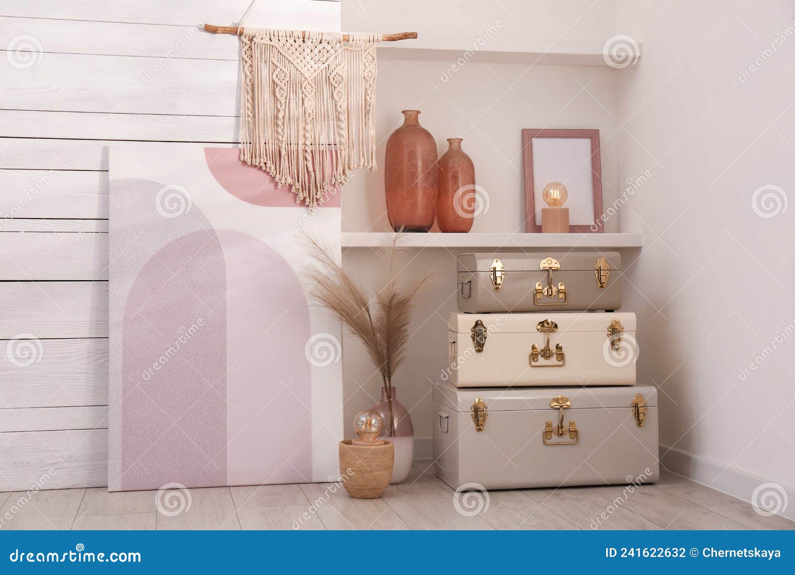 Stylish Storage Trunks and Different Decor Elements Near White Wall