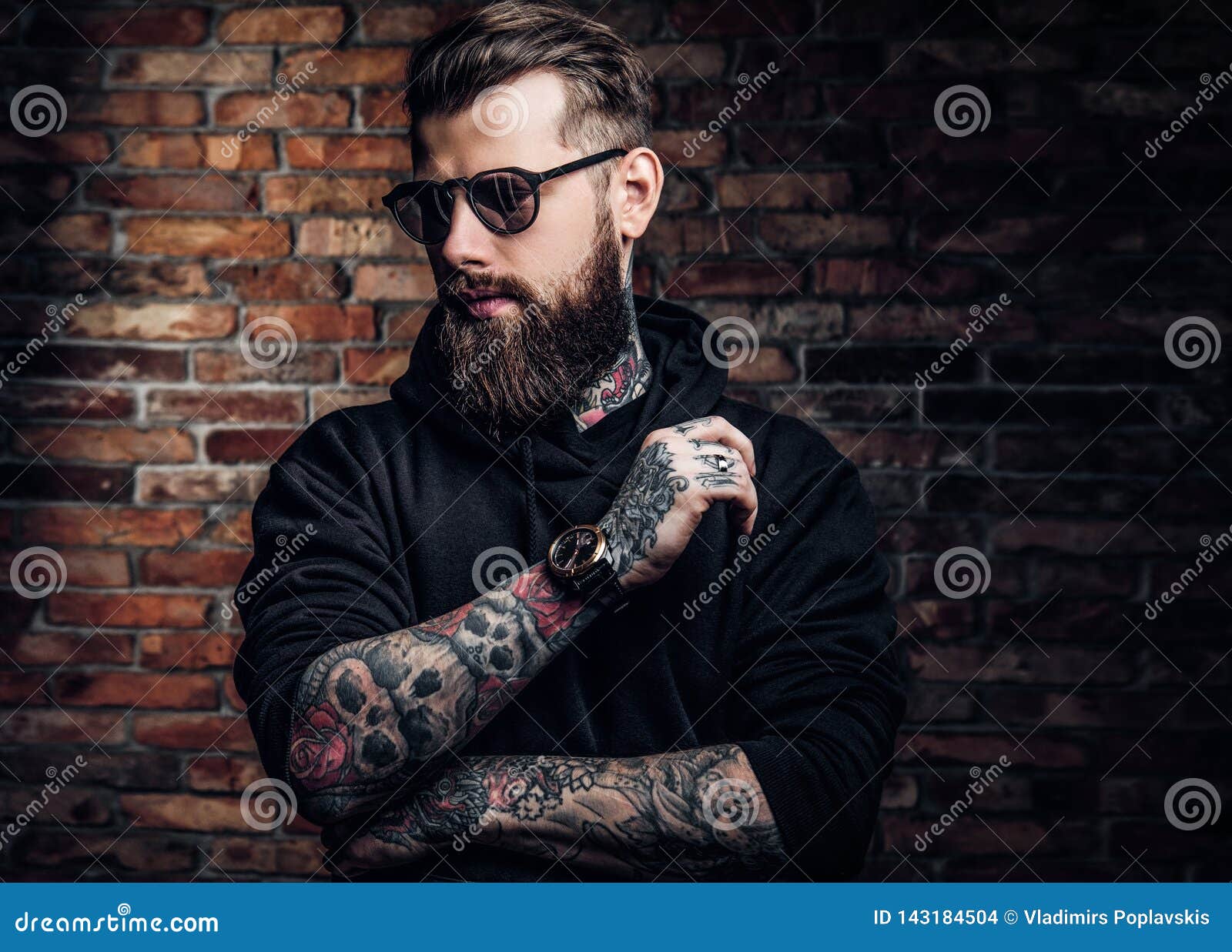 A Stylish Tattooed Guy in a Black Hoodie and Sunglasses. Studio Photo ...