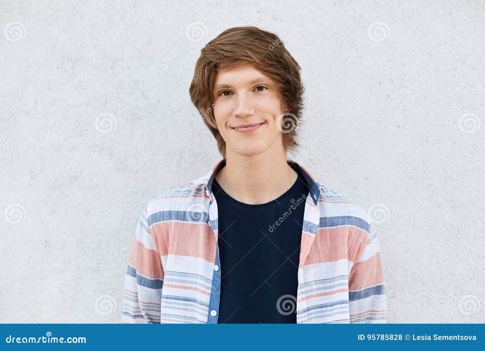 Stylish Teenage Boy with Trendy Hairstyle Having Dark Eyes, Pure Skin and  Dimples on Cheeks Wearing Shirt Standing Against White C Stock Photo -  Image of posing, cute: 95785828