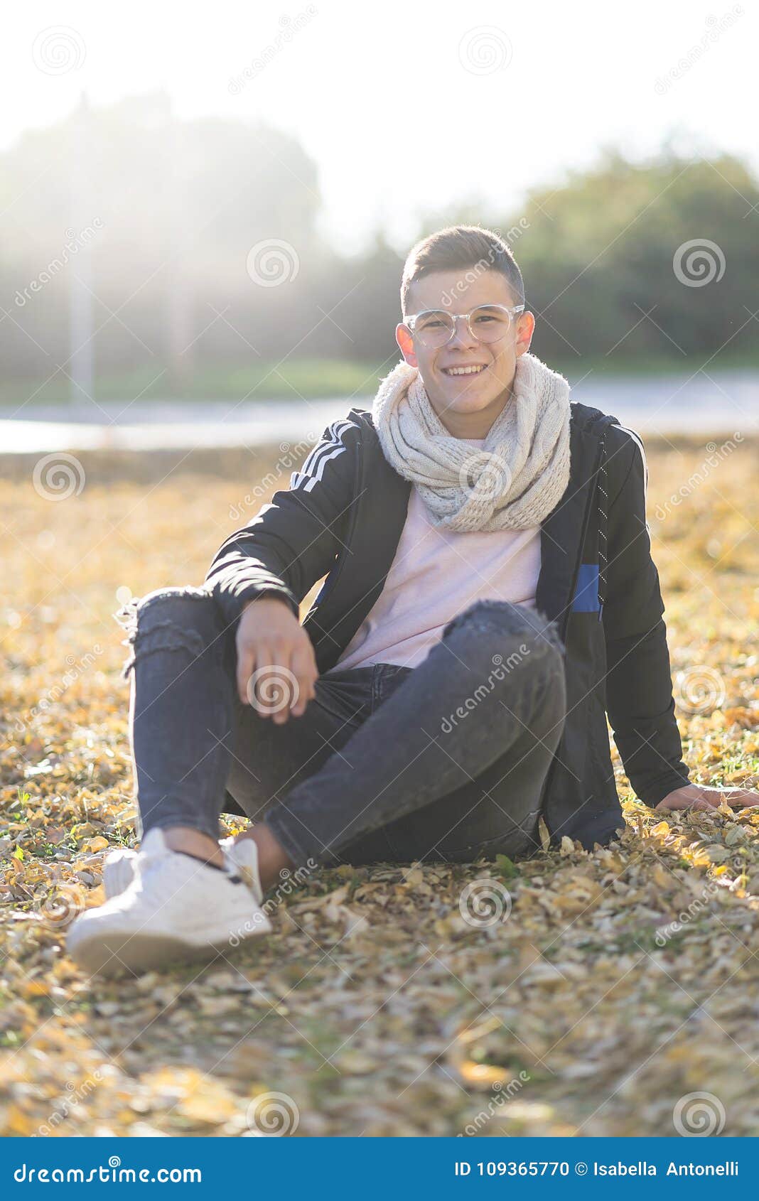 Stylish Smiling Teenager Sitting on the Ground in a City Park Stock ...