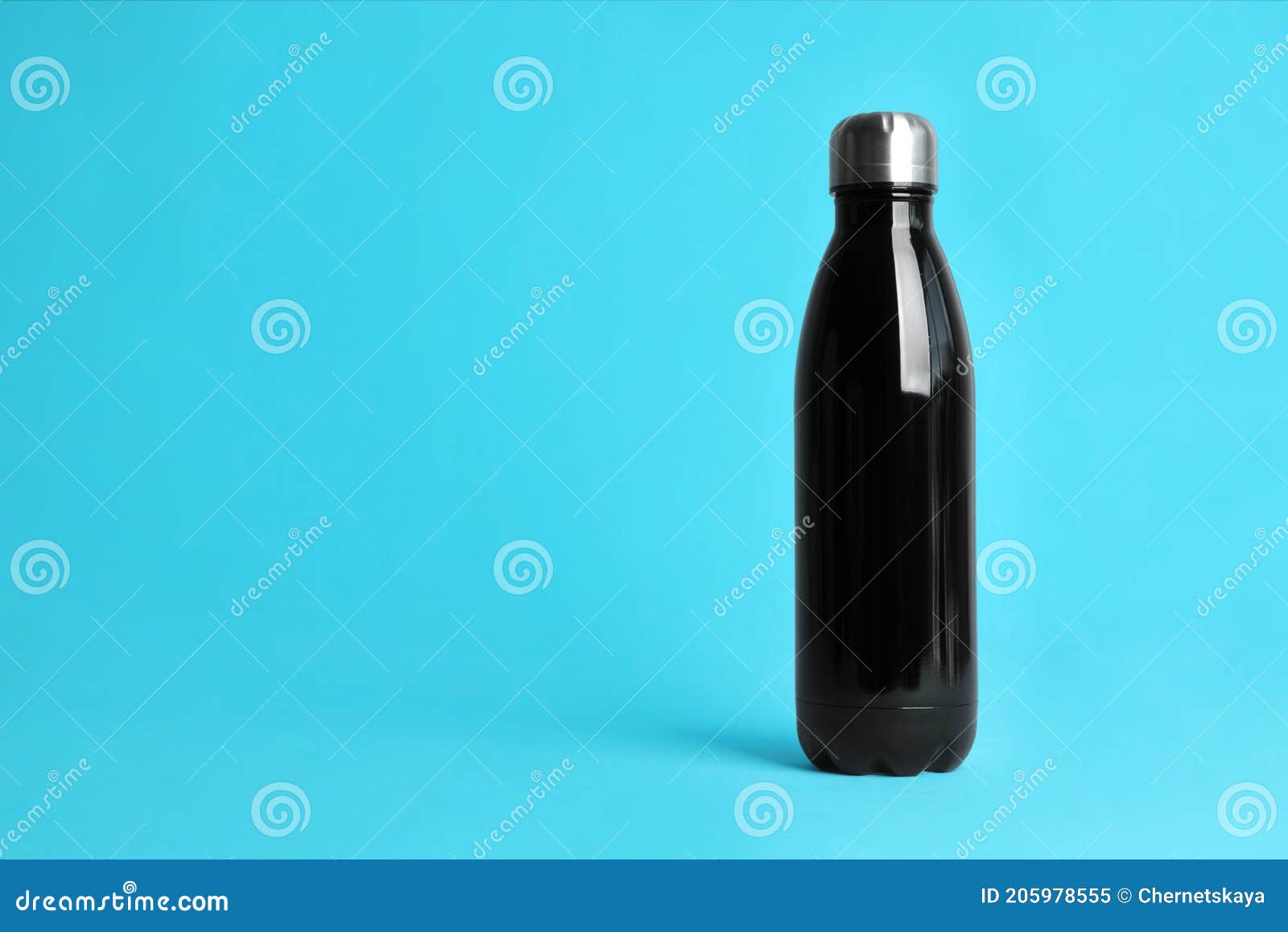 Stylish Thermo Bottle on Light Blue Background, Space for Text Stock
