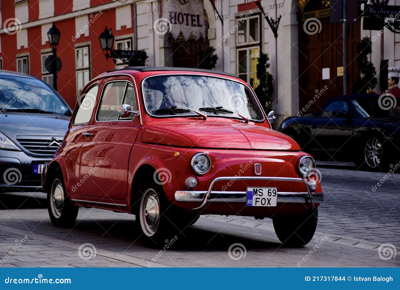 Vintage Red FIAT 500 Small Italian Car in Side View. Grunge Stucco