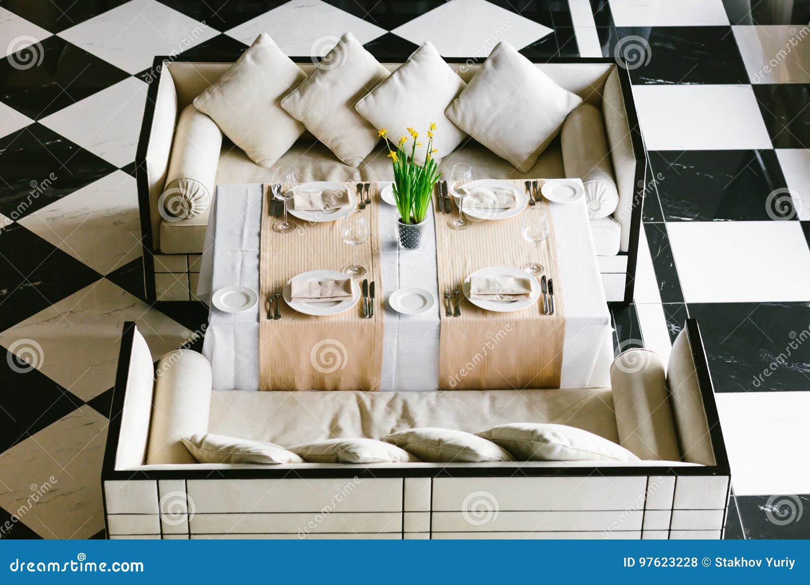Stylish White Dining Table and Sofas. Minimalist Interior in Monochrome