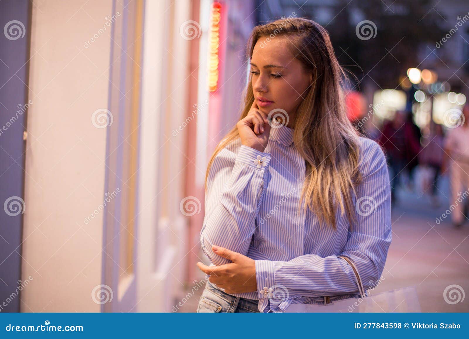 Stylish Woman in Front of a Store, Looking at Showcases Stock Photo ...