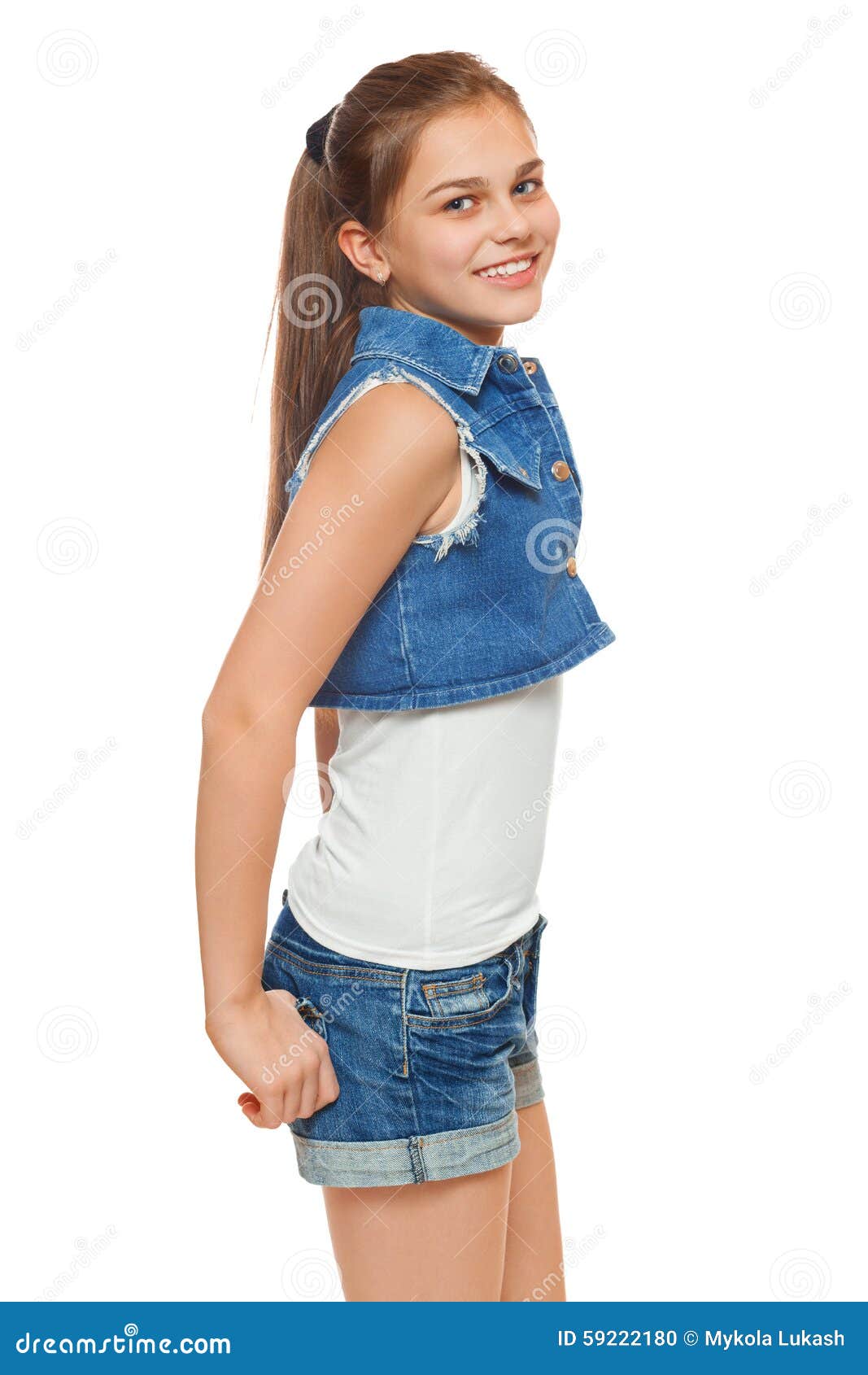 Stylish Young Girl in a Jeans Vest and Denim Shorts. Street Style ...