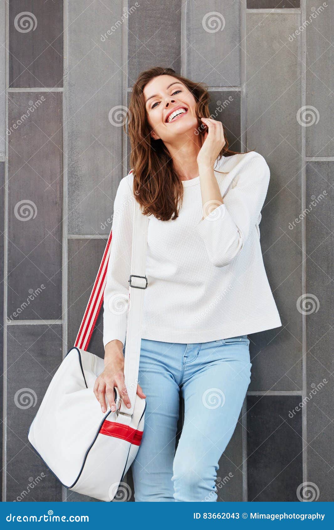 Stylish Young Woman Posing Against a Wall with Bag Stock Image - Image ...