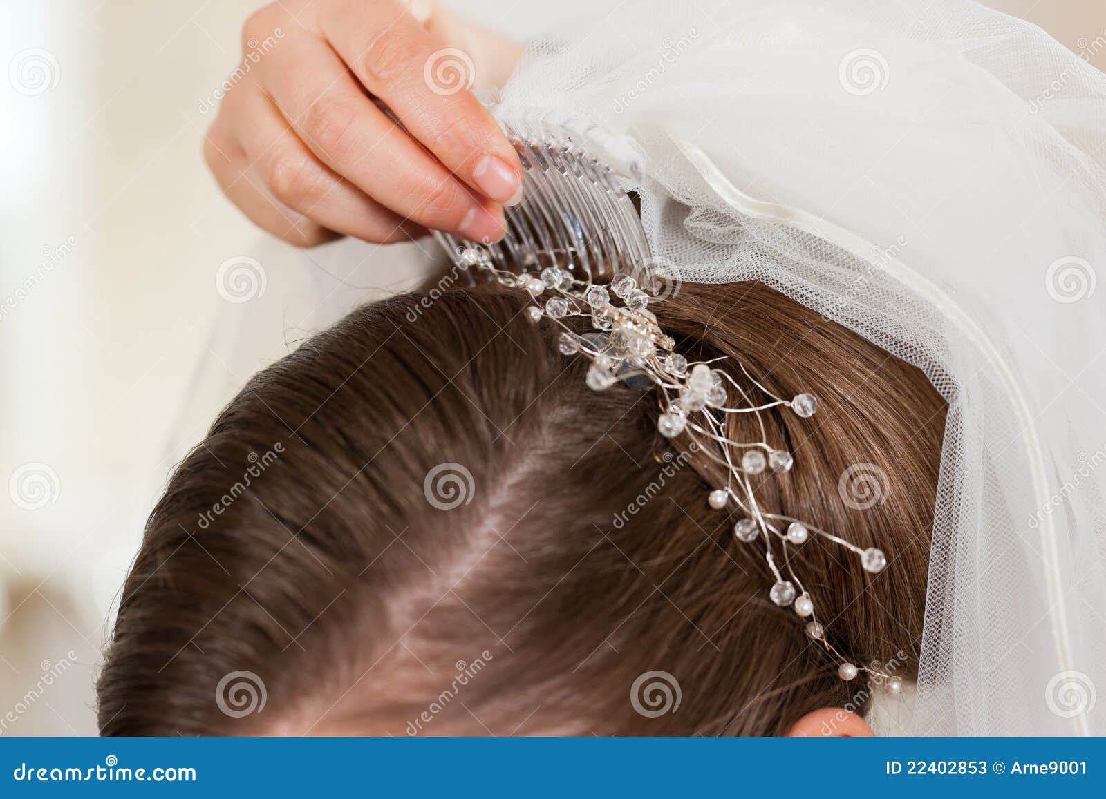 stylist pinning up a bride's hairstyle