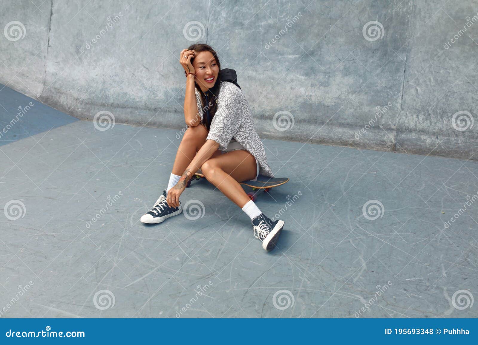 Subculture Skater Girl Sitting On Concrete Ramp At Skatepark Teenager In Casual Outfit Posing