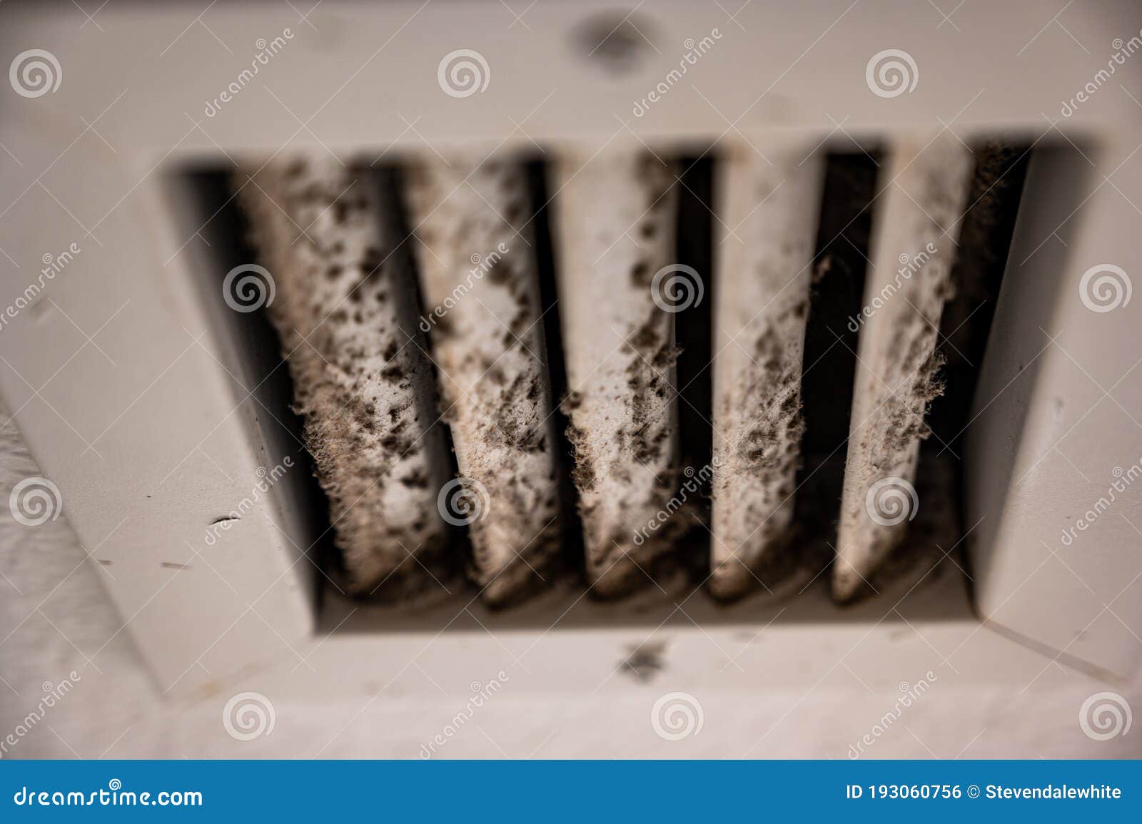 subjective focus on lint and dirt particles on a ceiling air vent