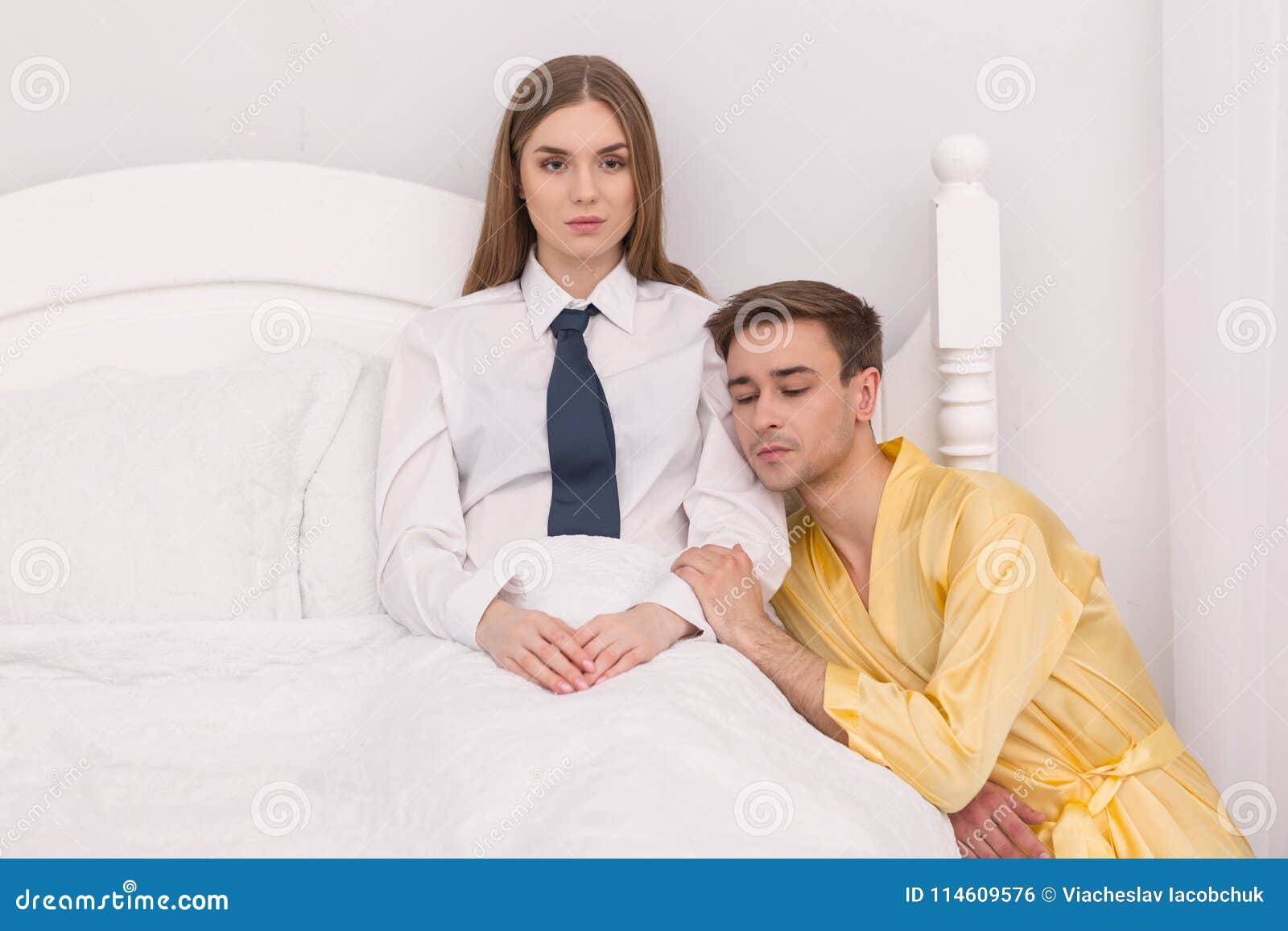 Submissive Boyfriend Sitting Near His Girls Bed Stock Photo image