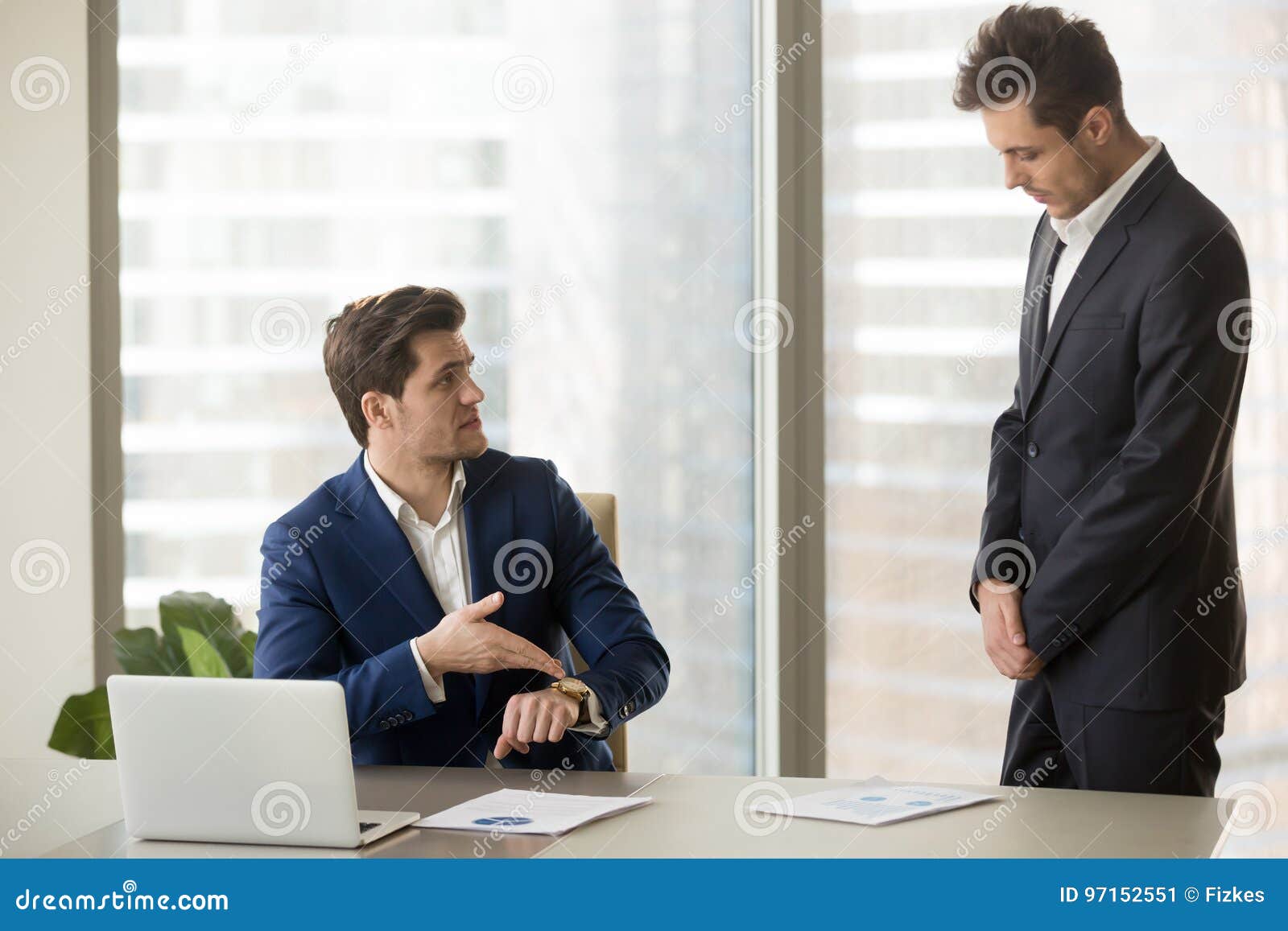 subordinate receiving reprimand from boss for being late, missin