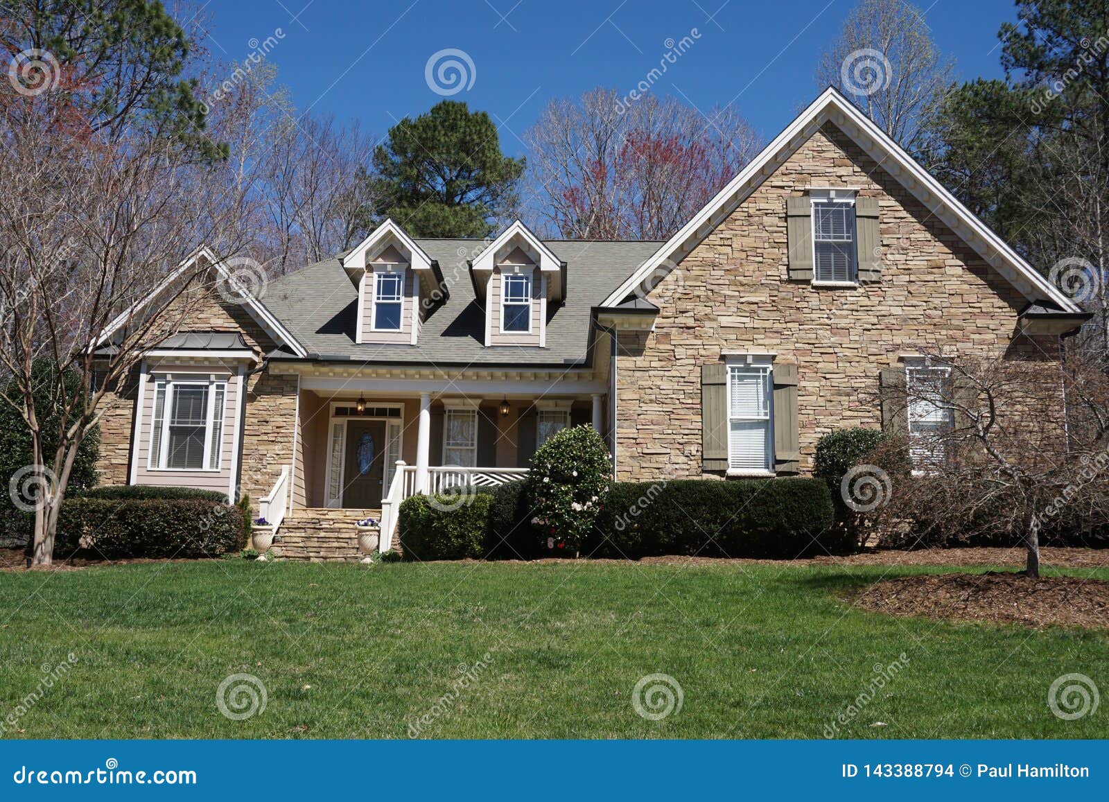 suburban house with stone exterior in an affluent neighborhood
