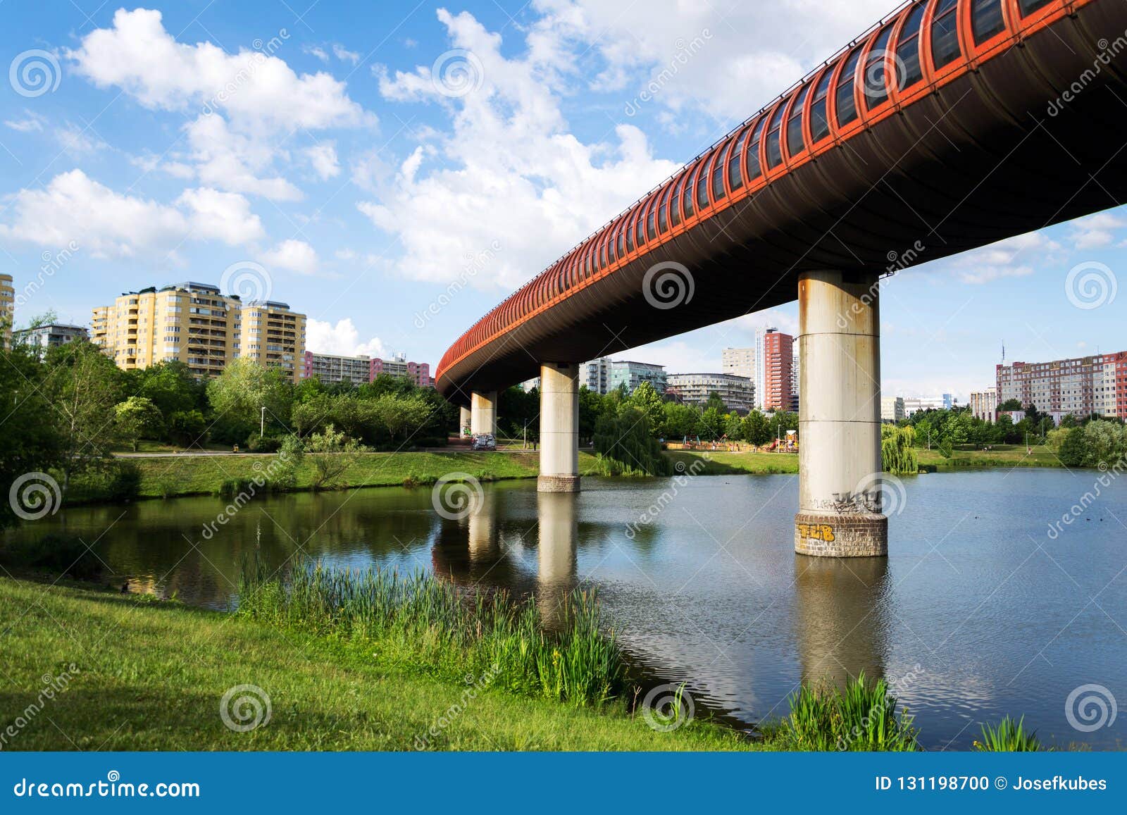 subway metro overground tunnel between stations hurka and luziny passing over pond, sunny summer day, prague