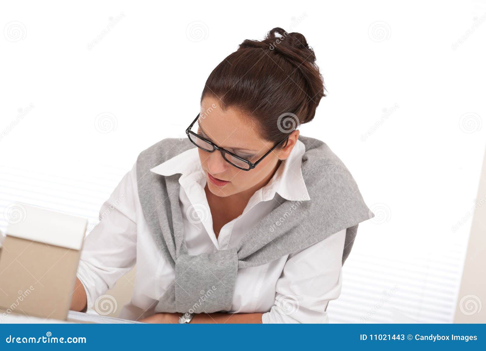 Successful architect woman working at office. Young female architect writing with pen at the office