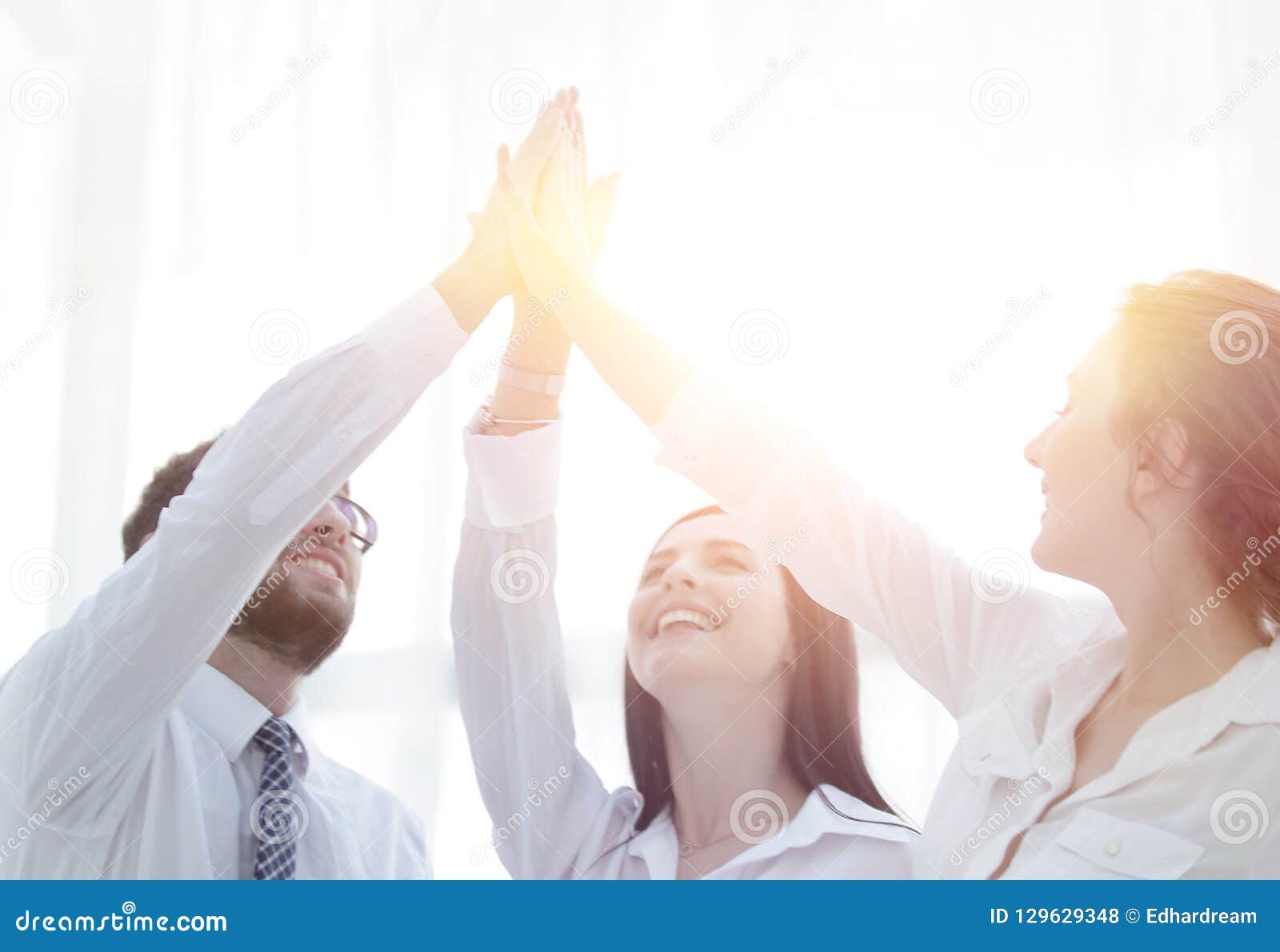 Successful Business Team Giving Each Other A High Five Stock Photo