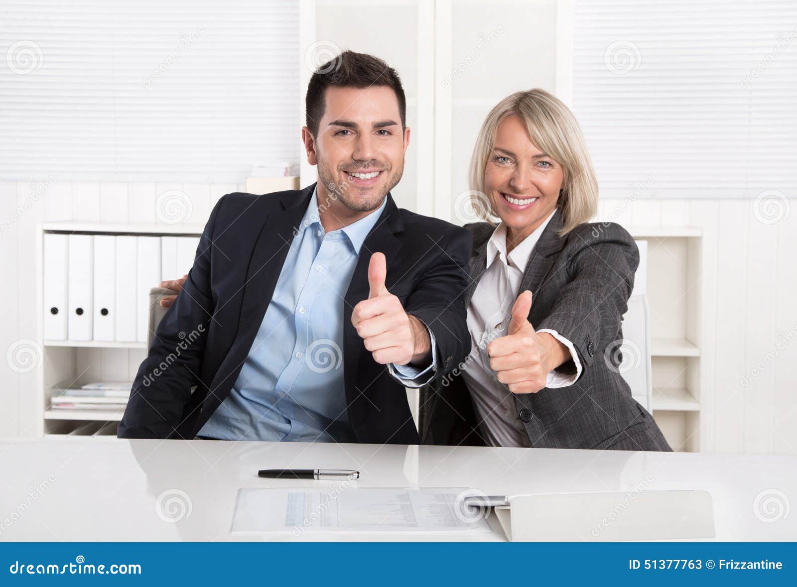 successful business team or happy business people making recommendation gesture.
