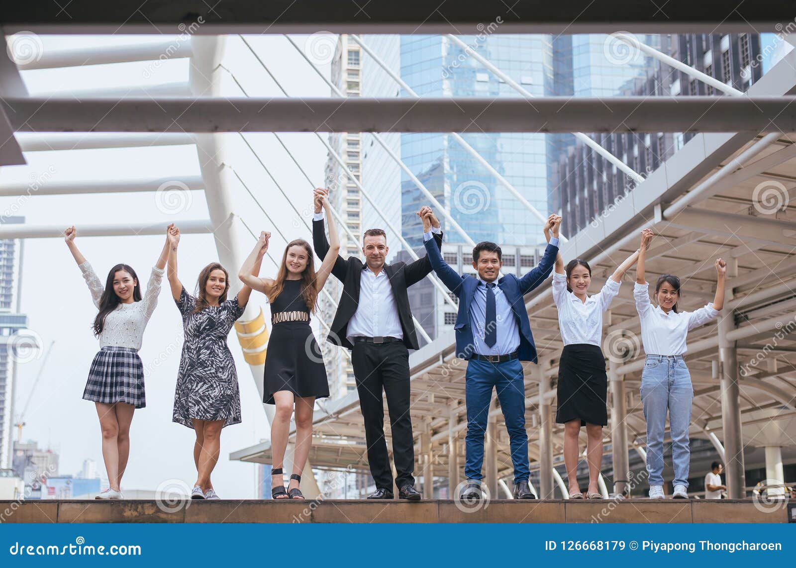 successful group of business people,success achievement hand raised,team work to achieve goals