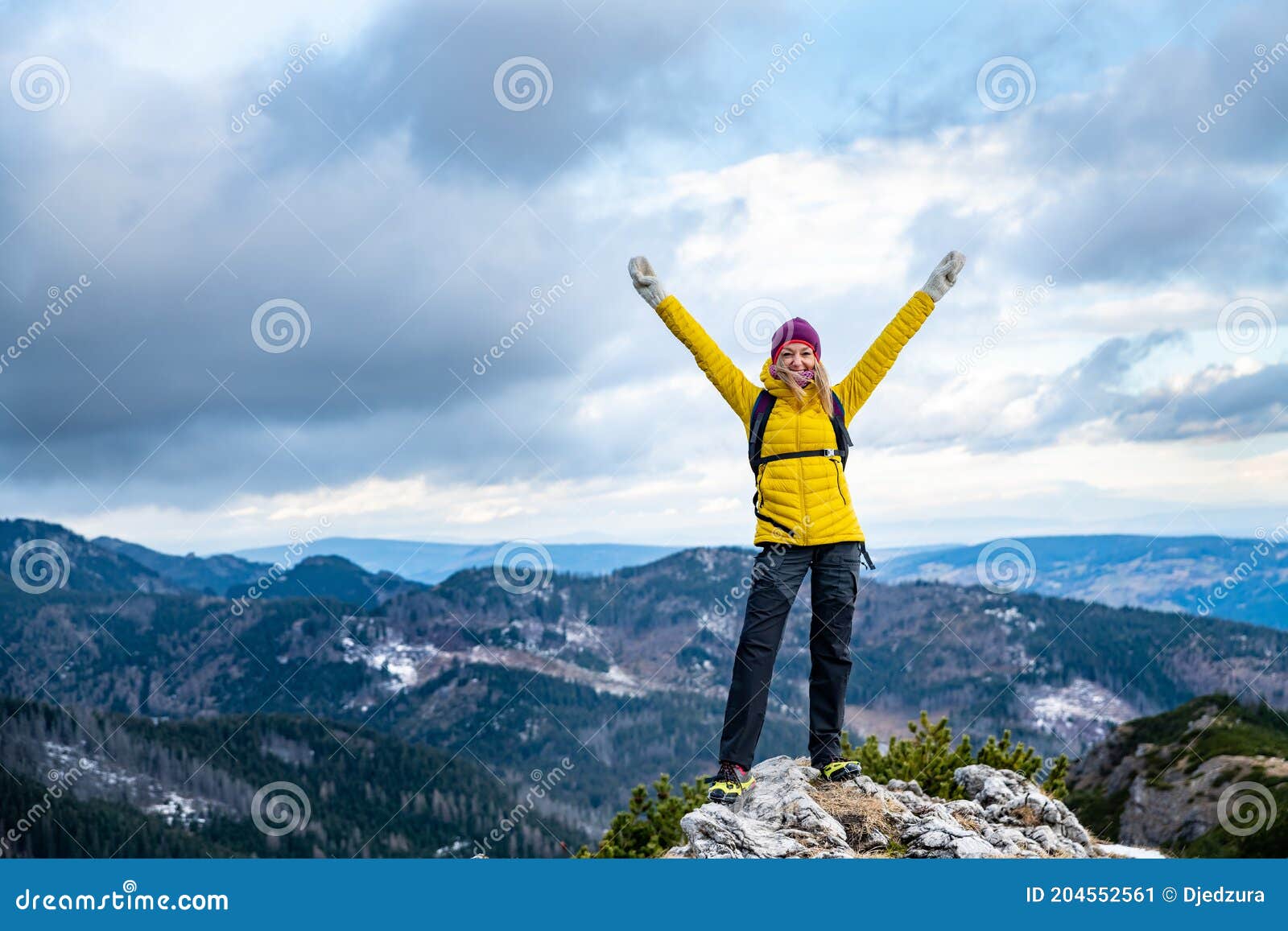 Successful Hiker Woman in a Yellow Down Jacket on the Top. Stock Image ...