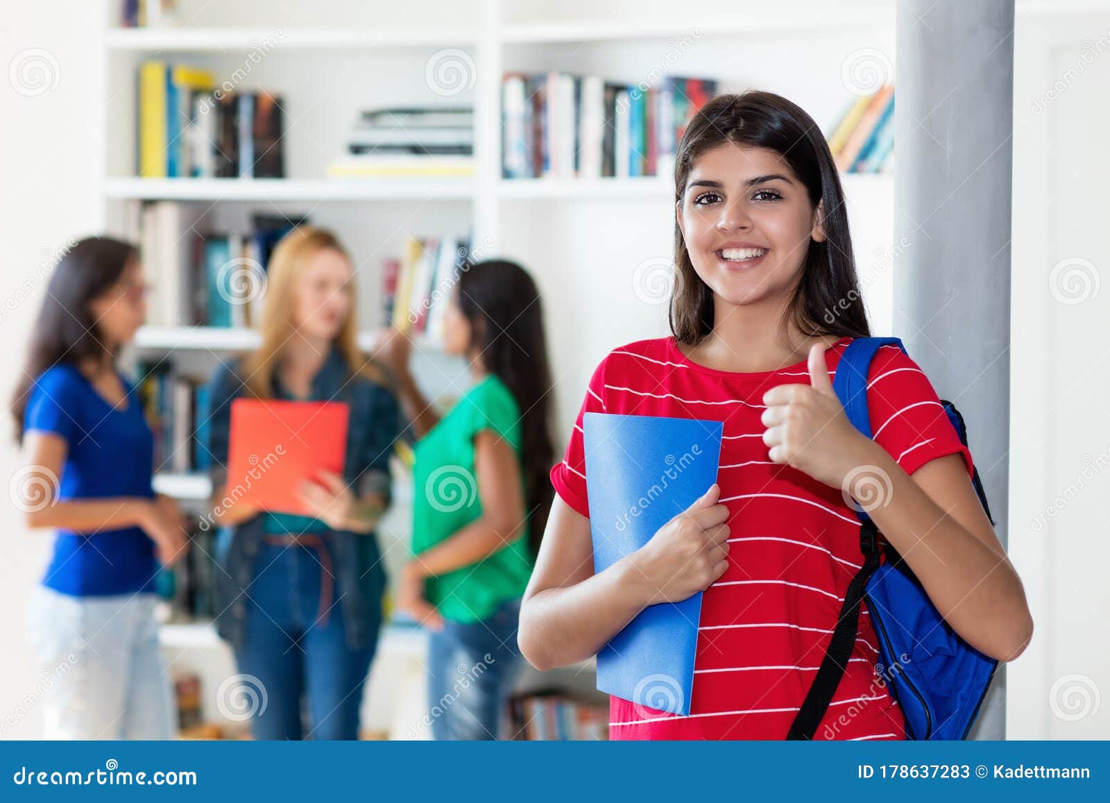 Successful Hispanic Female Student with Group of Multi Ethnic College
