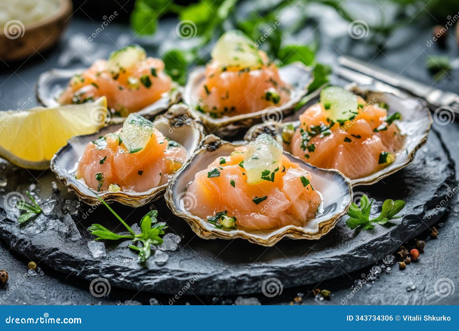 succulent oysters are elegantly topped with fresh, diced salmon, herbs, and citrus on a dark slate platter, creating a
