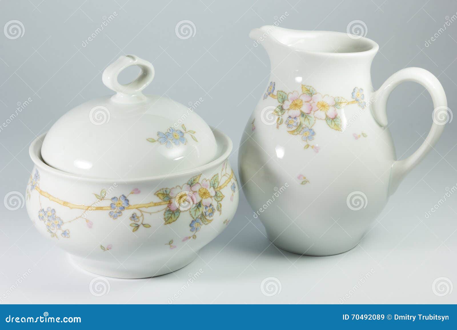 sugar bowl and milk jug with flowers on white background