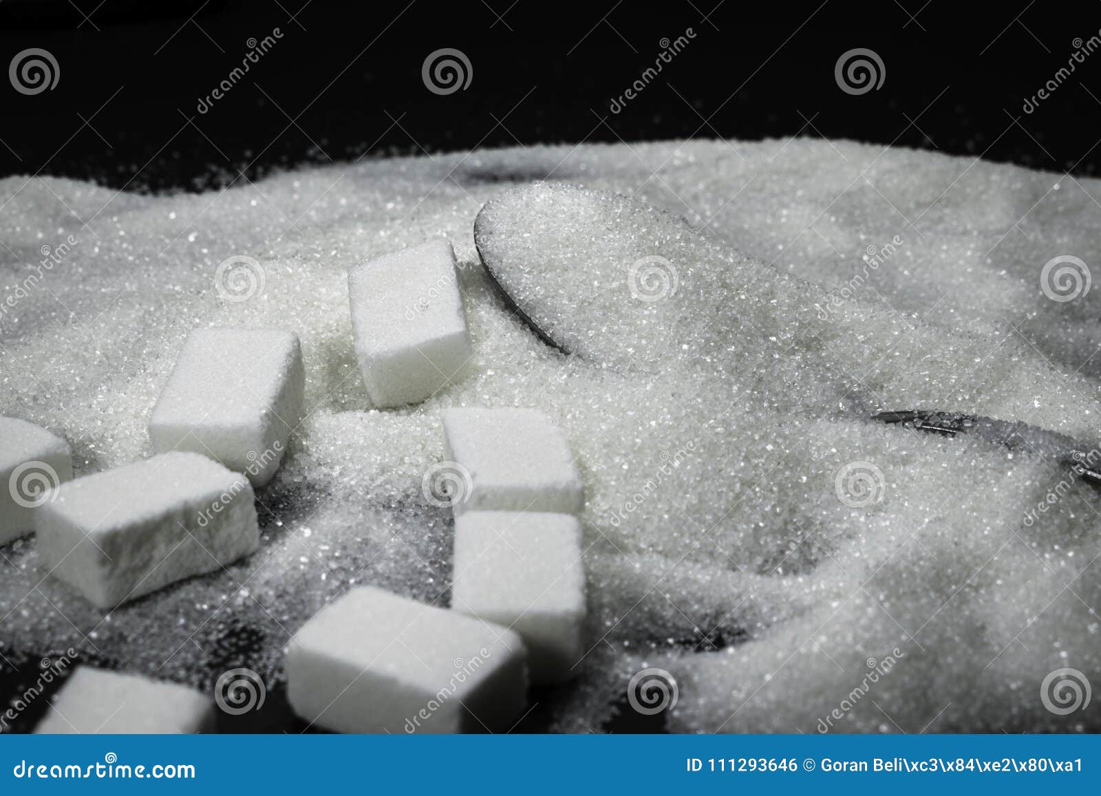 Sugar Cubes and Grain Sugar in a Spoon, Pile on Black Background Stock ...