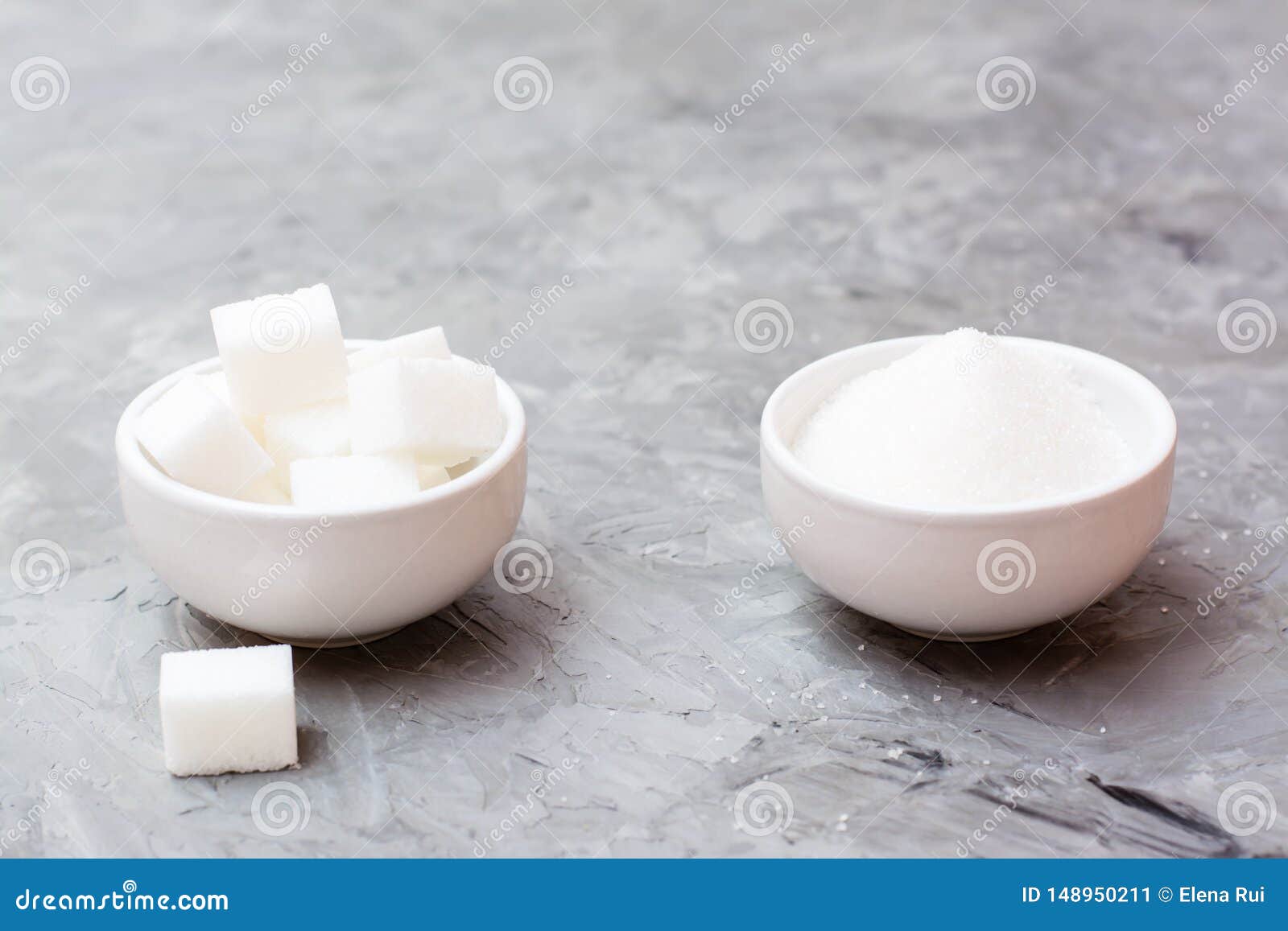 Sugar Cubes and Granulated Sugar in White Bowls on a Table Stock Image