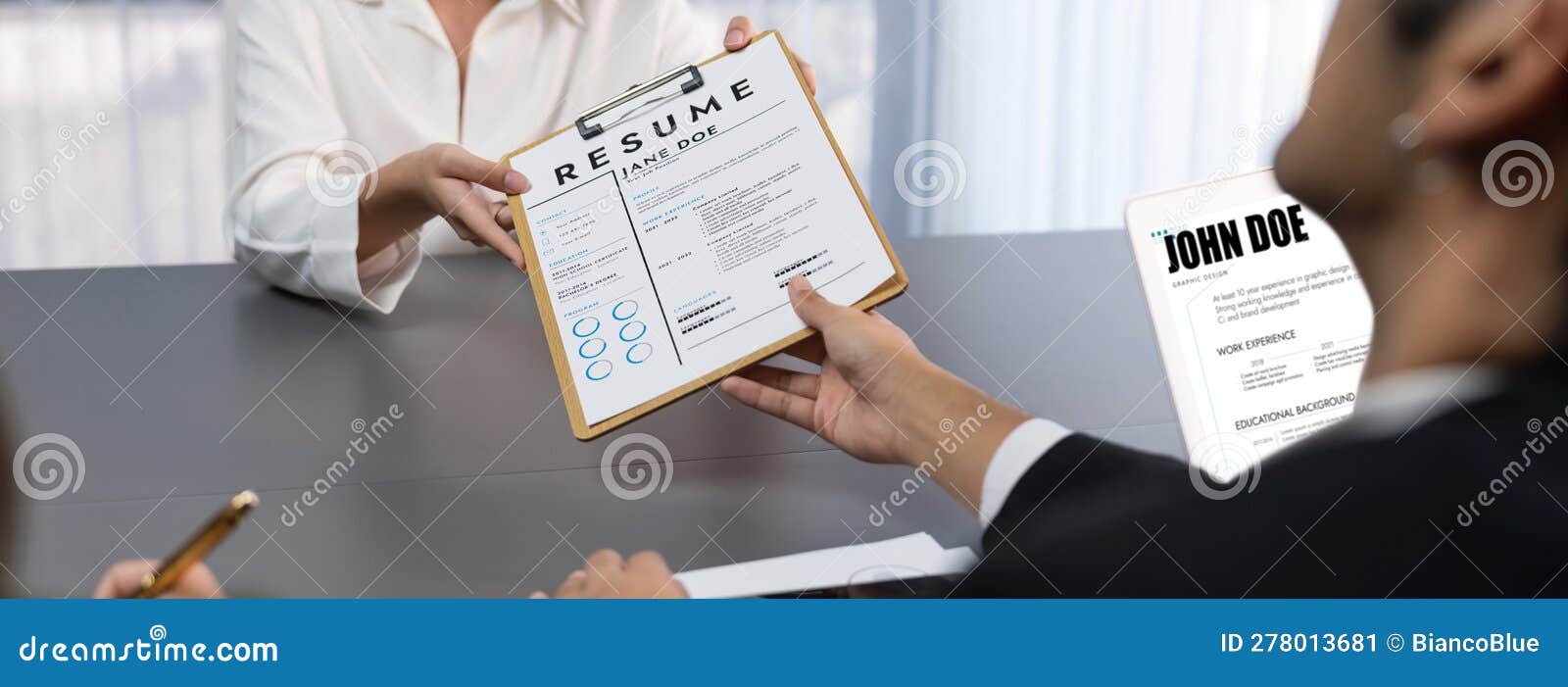 Suitclad Candidate Hand Over Resume To Interviewers. Prodigy Stock