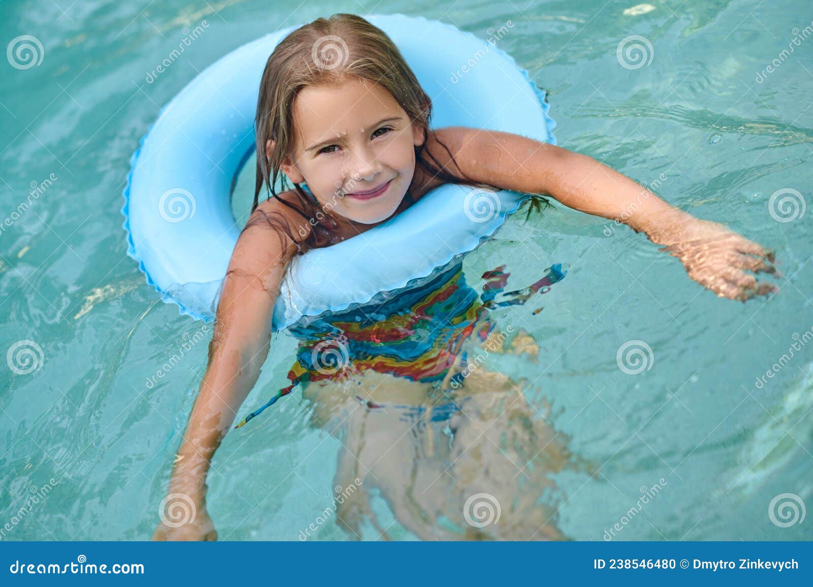 Sweet Little Girl Swimming on a Tube and Smiling Stock Photo - Image of ...