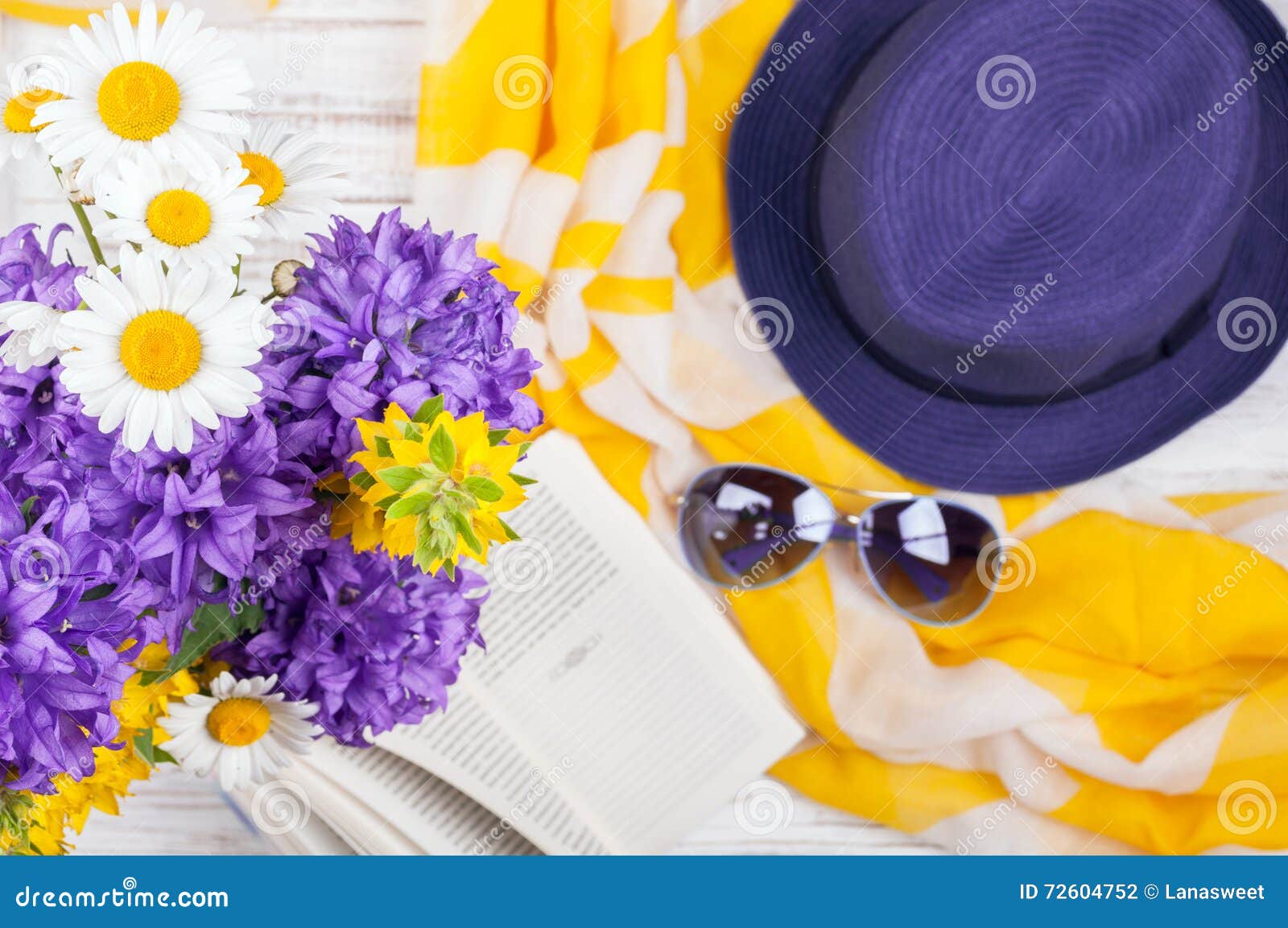 summer background with flowers, book and womans accessories